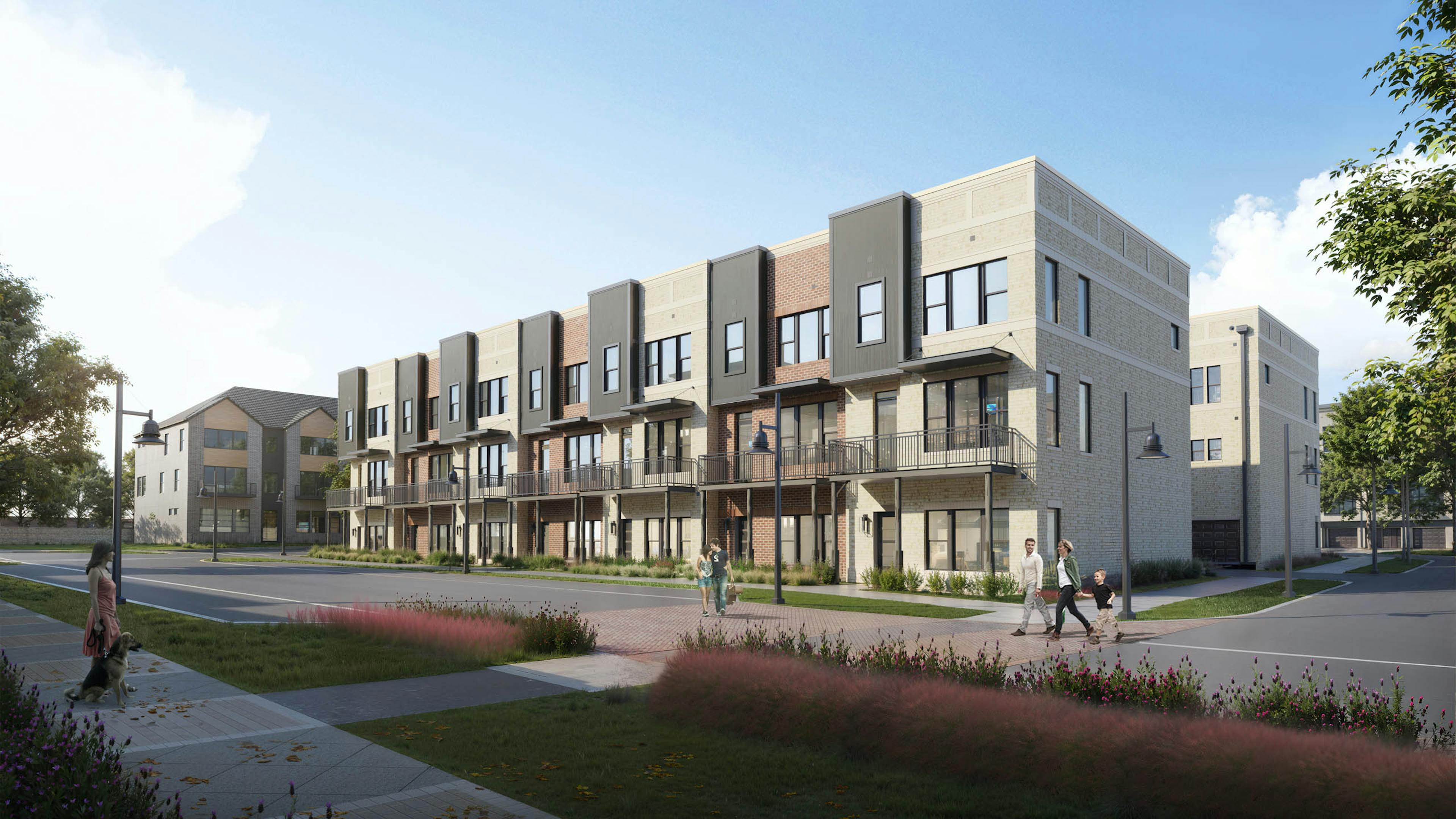 Exterior view of a three-story brick townhome building at AMLI Treehouse on a sunny day with people, grass and plants