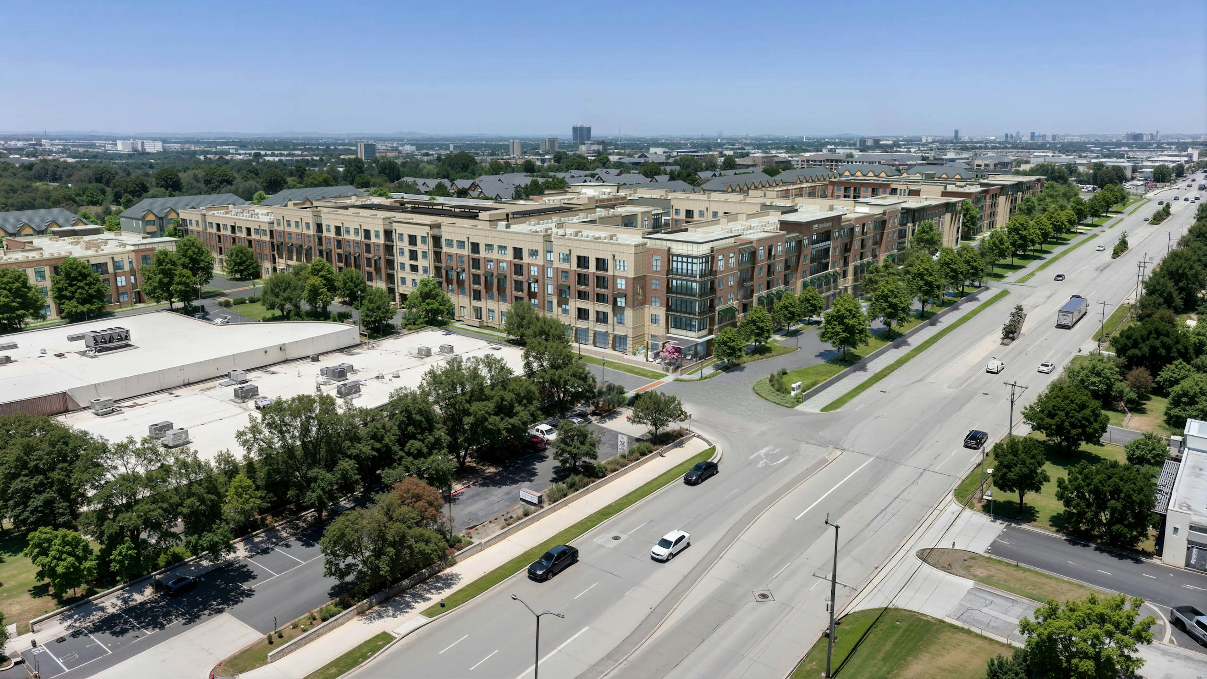 Aerial AMLI Treehouse rendering of the property with all buildings and green trees in the medians with a busy street in front of the buildings