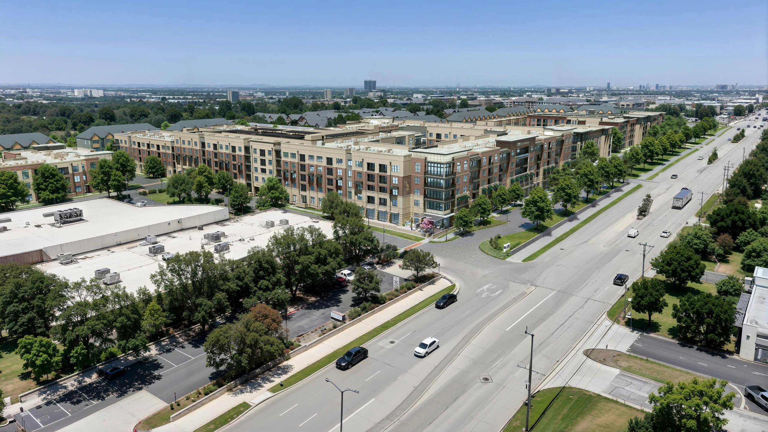 Aerial AMLI Treehouse rendering of the property with all buildings and green trees in the medians with a busy street in front of the buildings