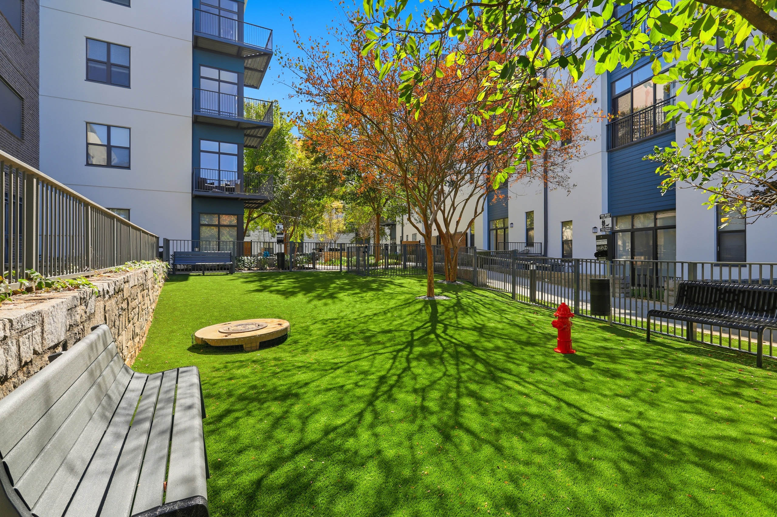 AMLI Old 4th Ward gated pet park with bench seating and a fire hydrant