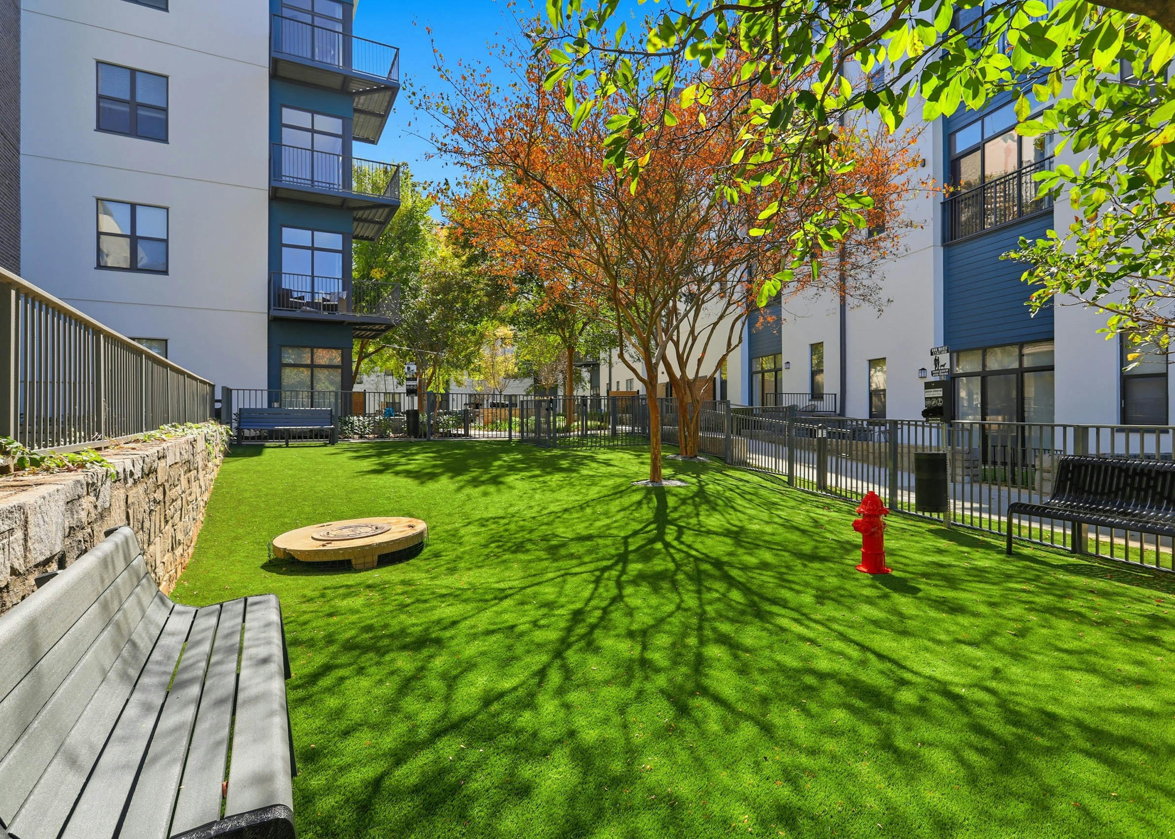 AMLI Old 4th Ward gated pet park with bench seating and a fire hydrant