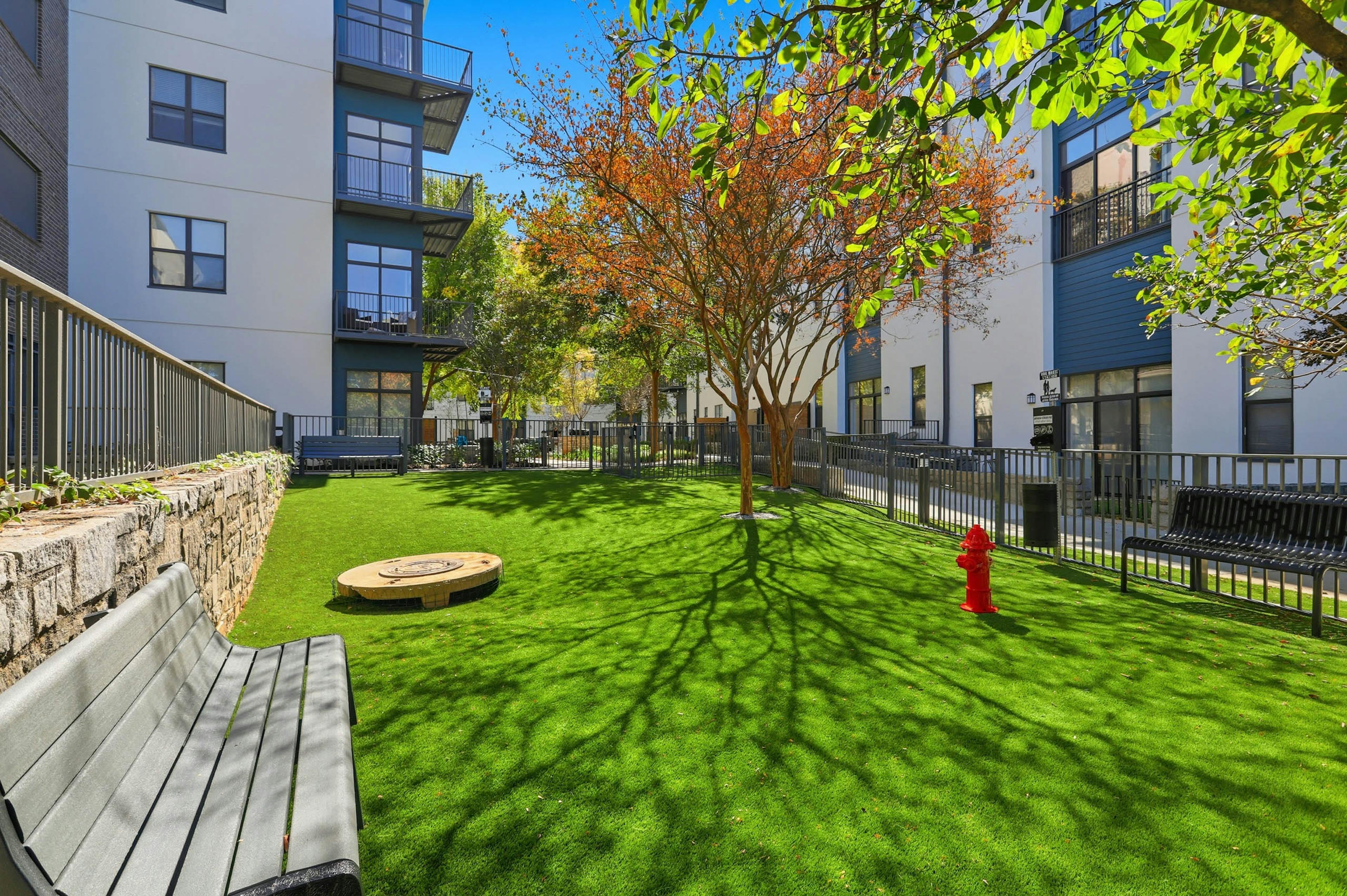 AMLI Old 4th Ward gated pet park with bench seating and a fire hydrant