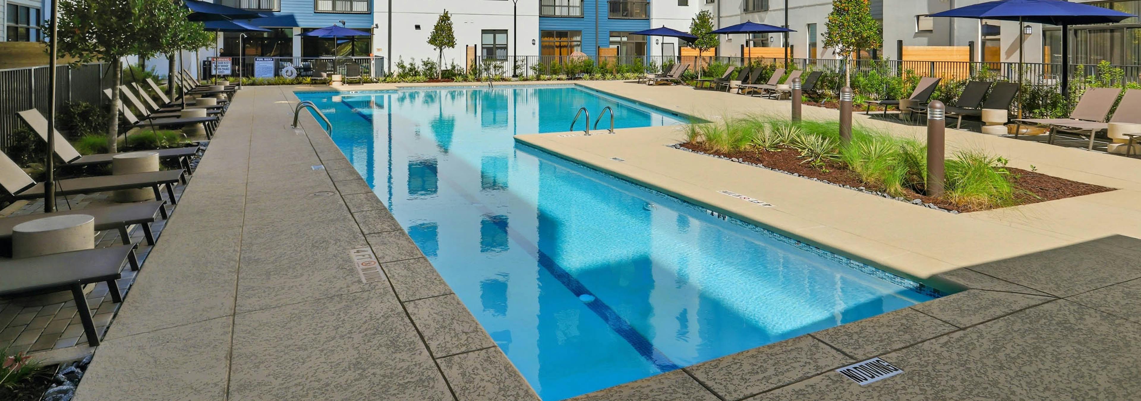 AMLI Old 4th Ward lap swimming pool with lounge chairs and umbrellas