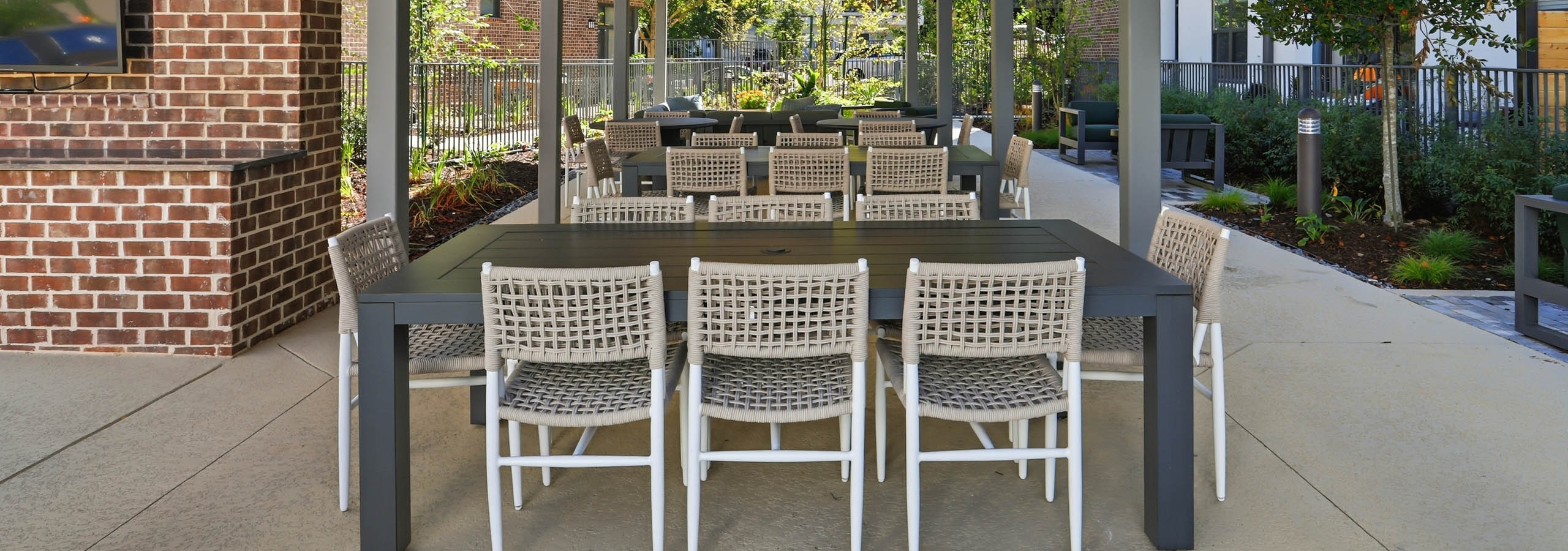 Large covered outdoor dining area with TV at AMLI Old 4th Ward