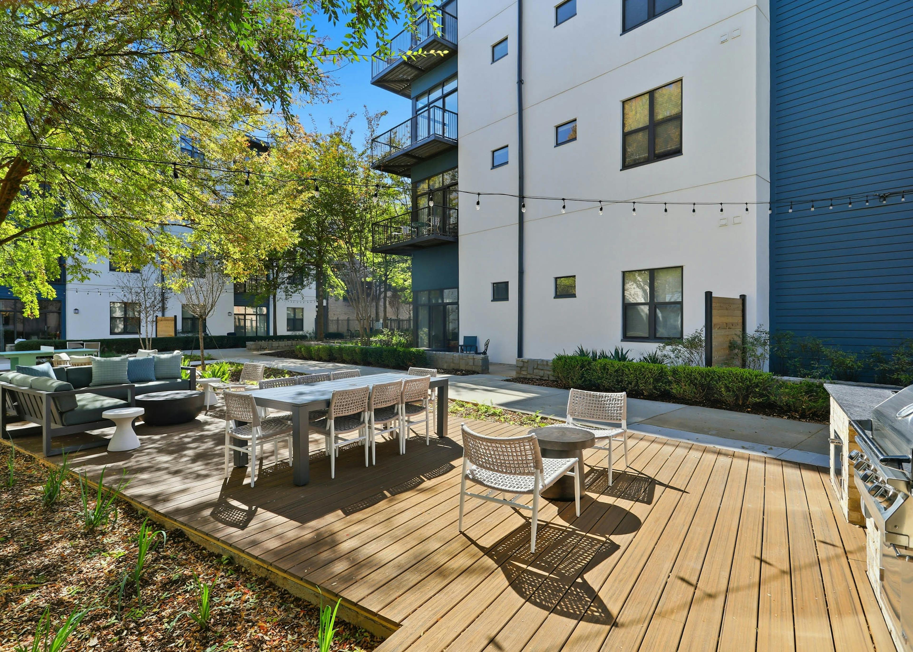 Lounge area and outdoor kitchen at AMLI Old 4th Ward with string lights