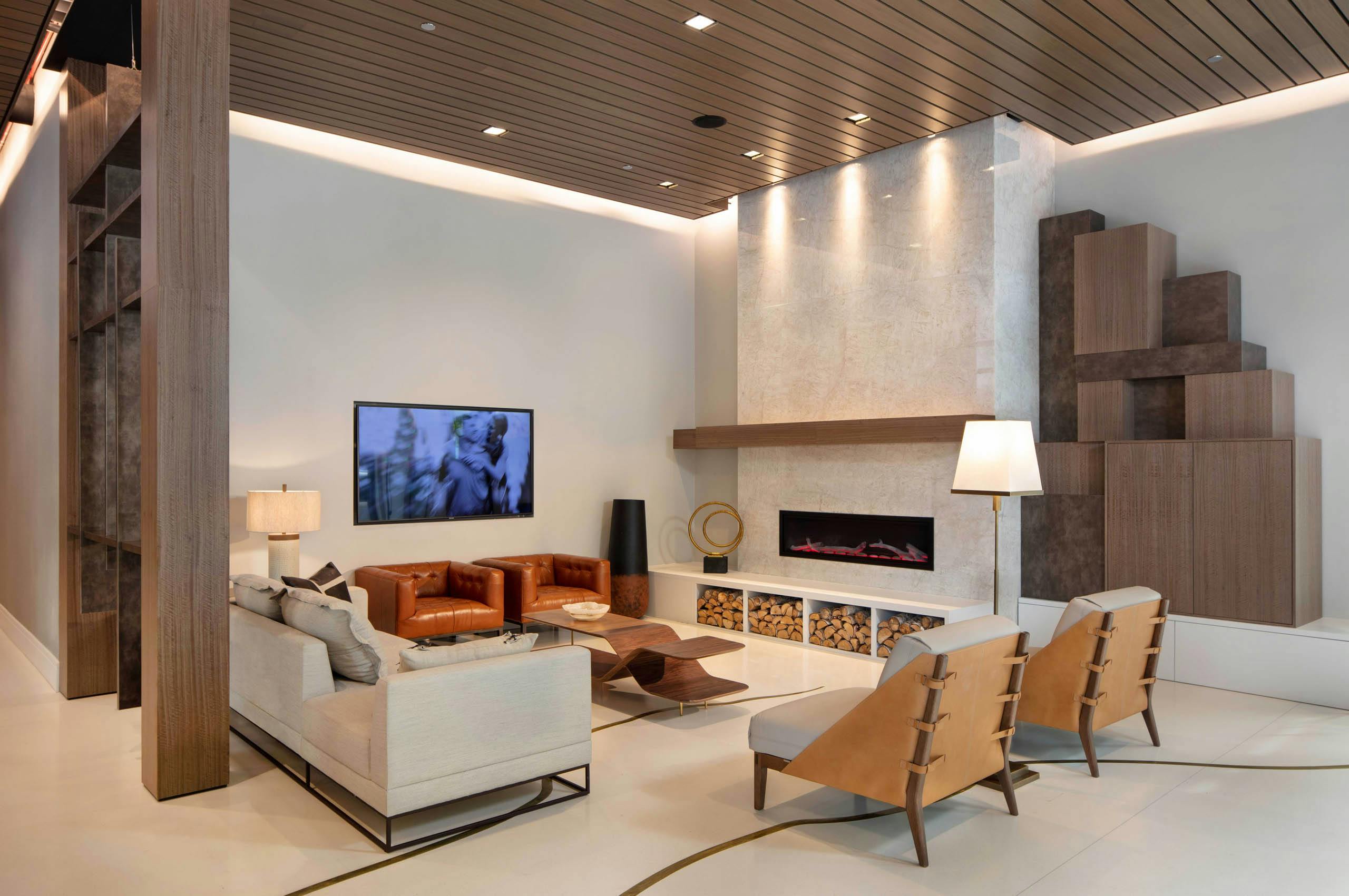 AMLI West Loop lobby with comfortable seating and a mounted TV featuring a fireplace and a wood slat ceiling.
