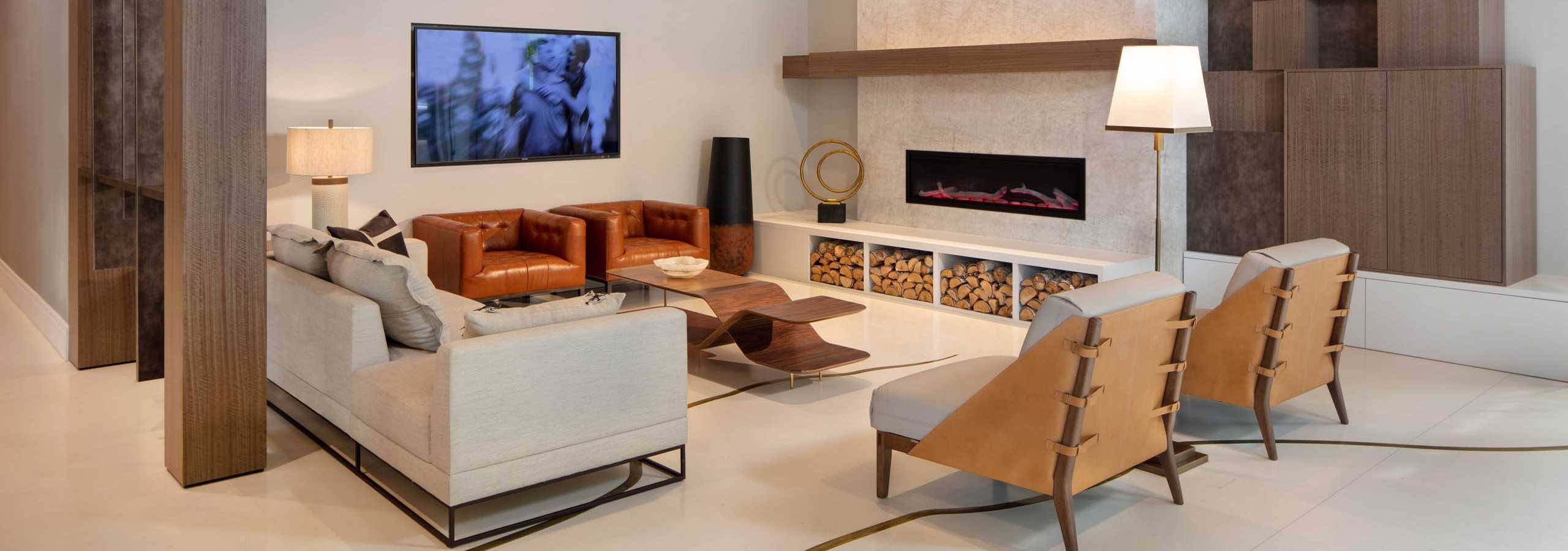 AMLI West Loop lobby with comfortable seating and a mounted TV featuring a fireplace and a wood slat ceiling.