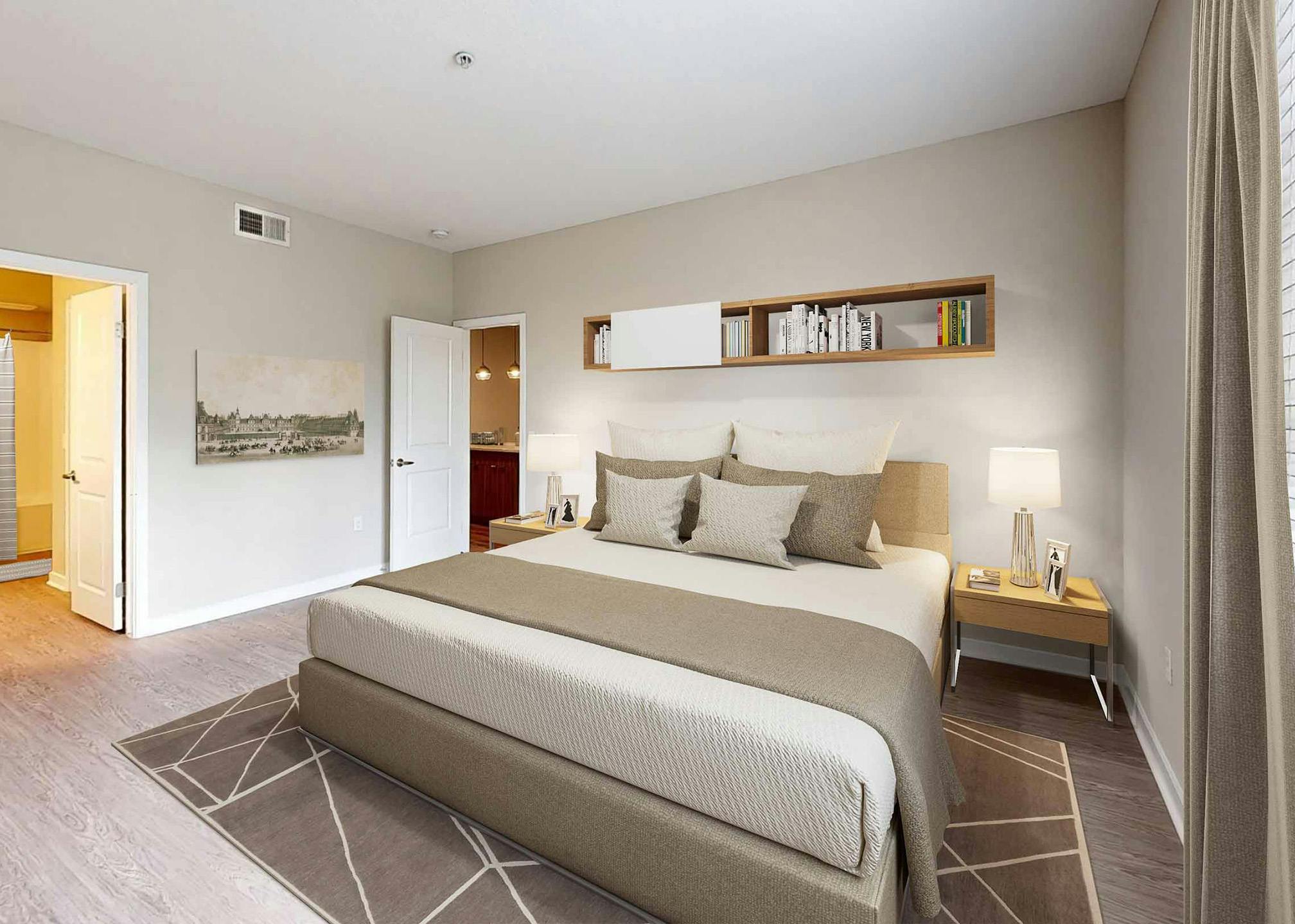 AMLI Camarillo apartment bedroom with king bed, floating bookshelf, two nightstands, potted plant, wall art and glimpse into the bathroom.