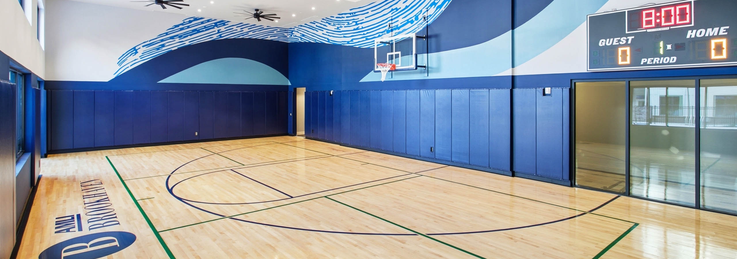 AMLI Brookhaven indoor sport court with a basketball hoop and electronic score board.