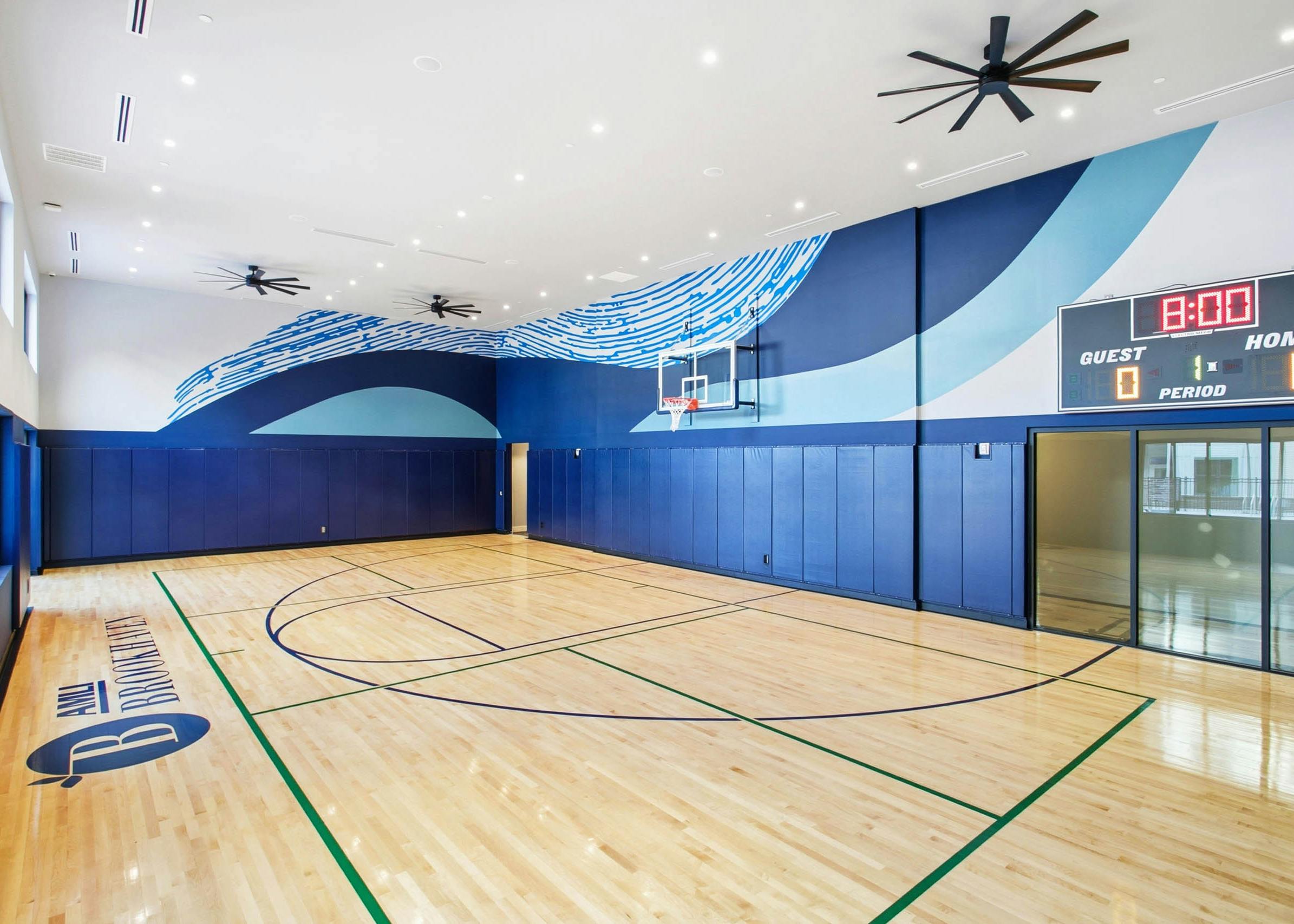 AMLI Brookhaven indoor sport court with a basketball hoop and electronic score board.