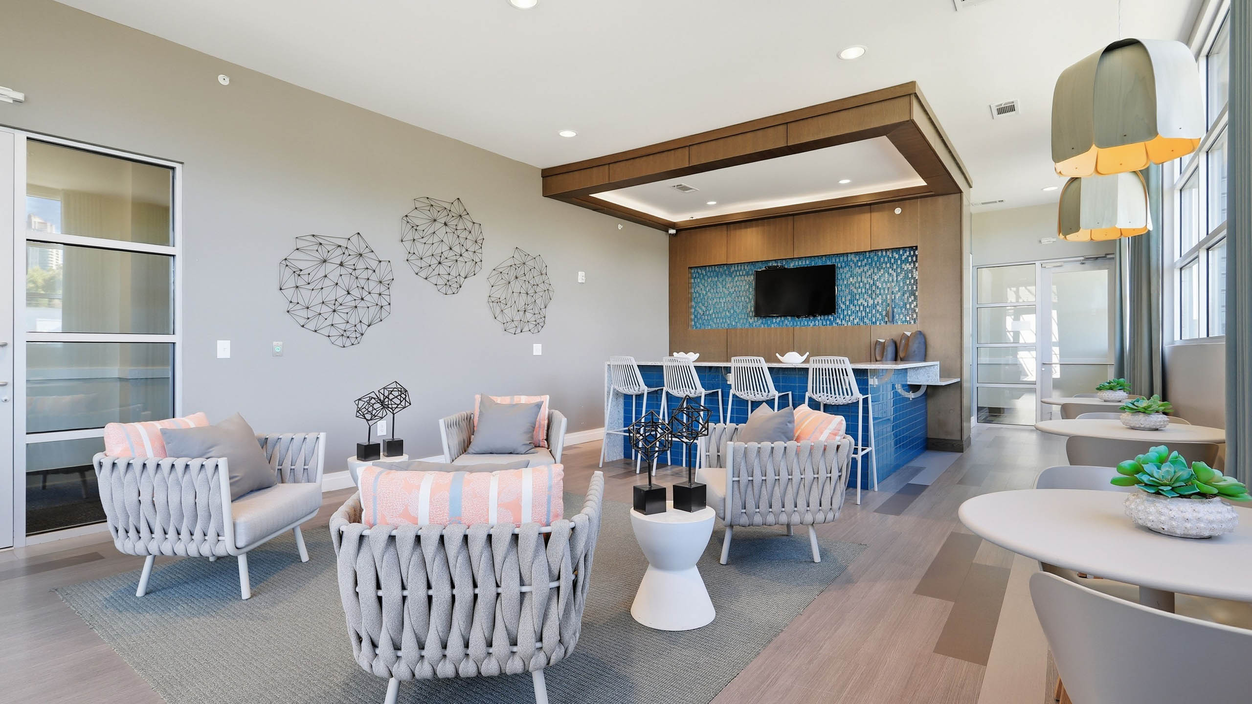 An interior view of a resident lounge at AMLI Buckhead with a large seating area and a flat screen television and wall art