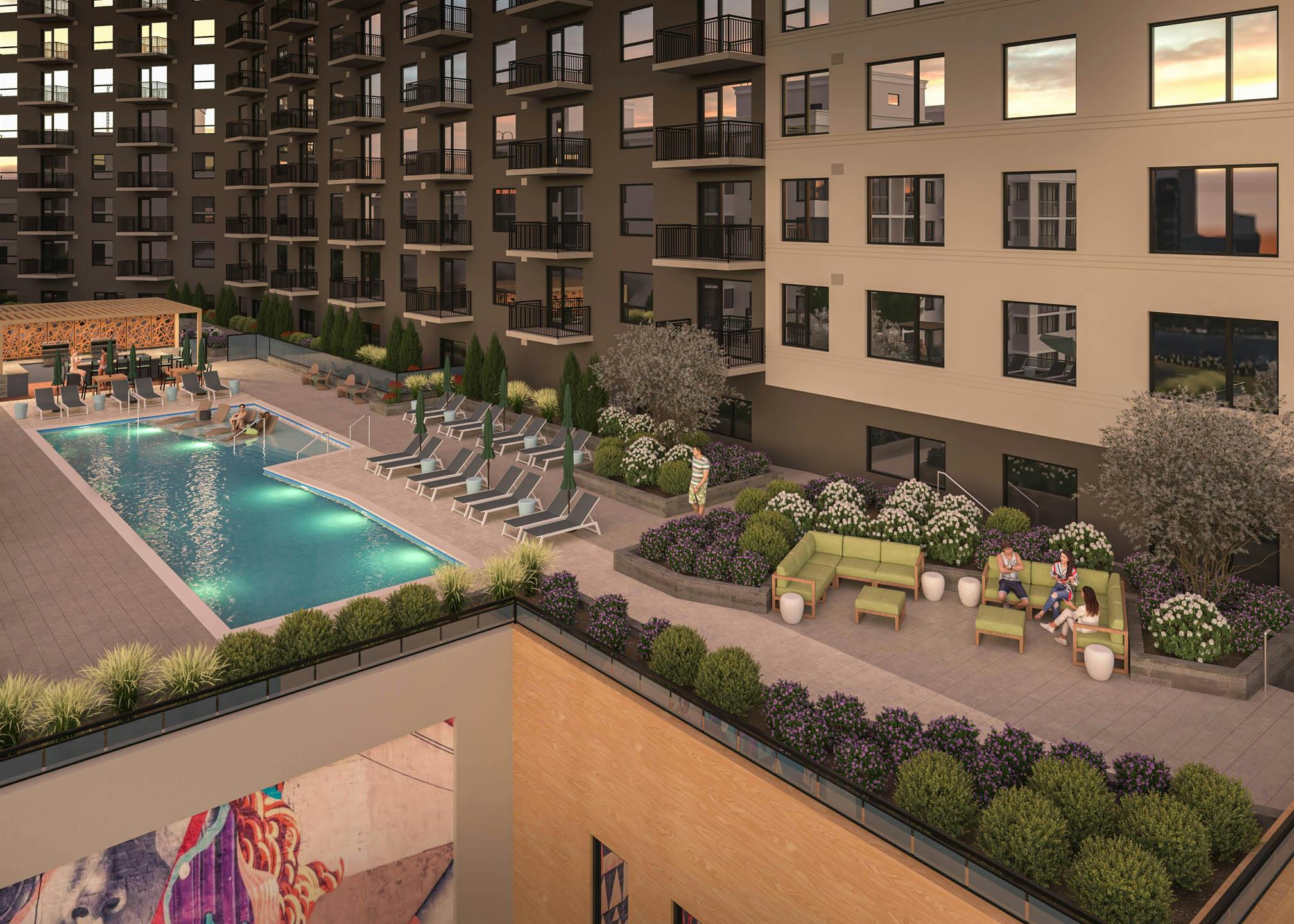 Exterior view of rooftop terrace with outdoor pool and lounge chairs and landscaped plants at AMLI Golden Triangle.