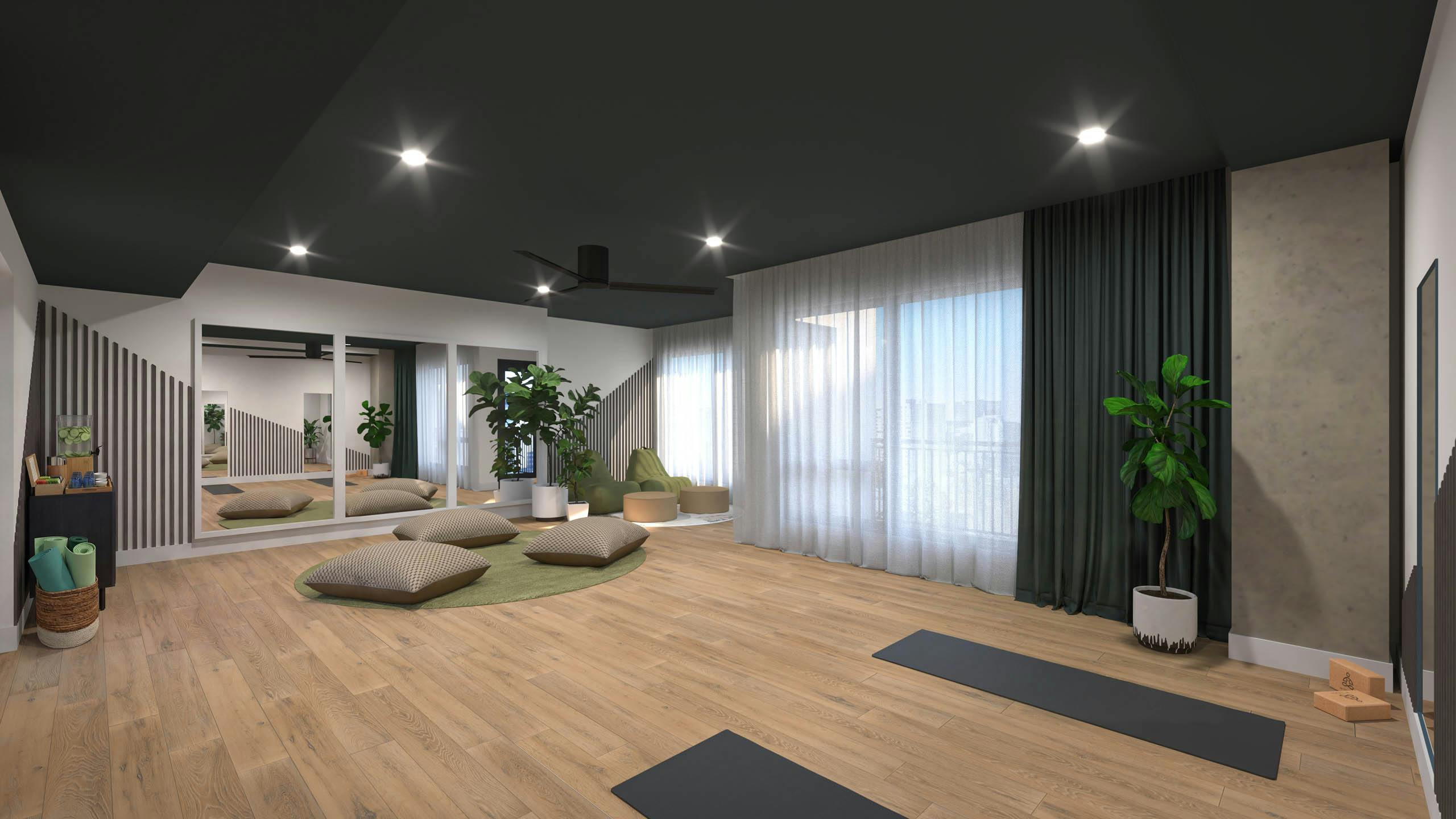 Interior view of yoga studio amenity with fitness equipment and cushions with mirrors at AMLI Golden Triangle.