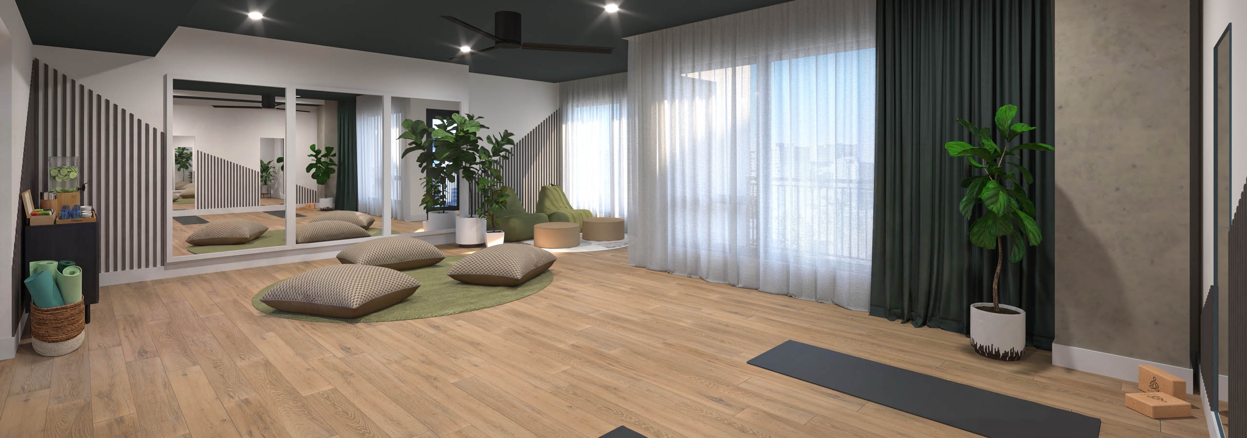Interior view of yoga studio amenity with fitness equipment and cushions with mirrors at AMLI Golden Triangle.