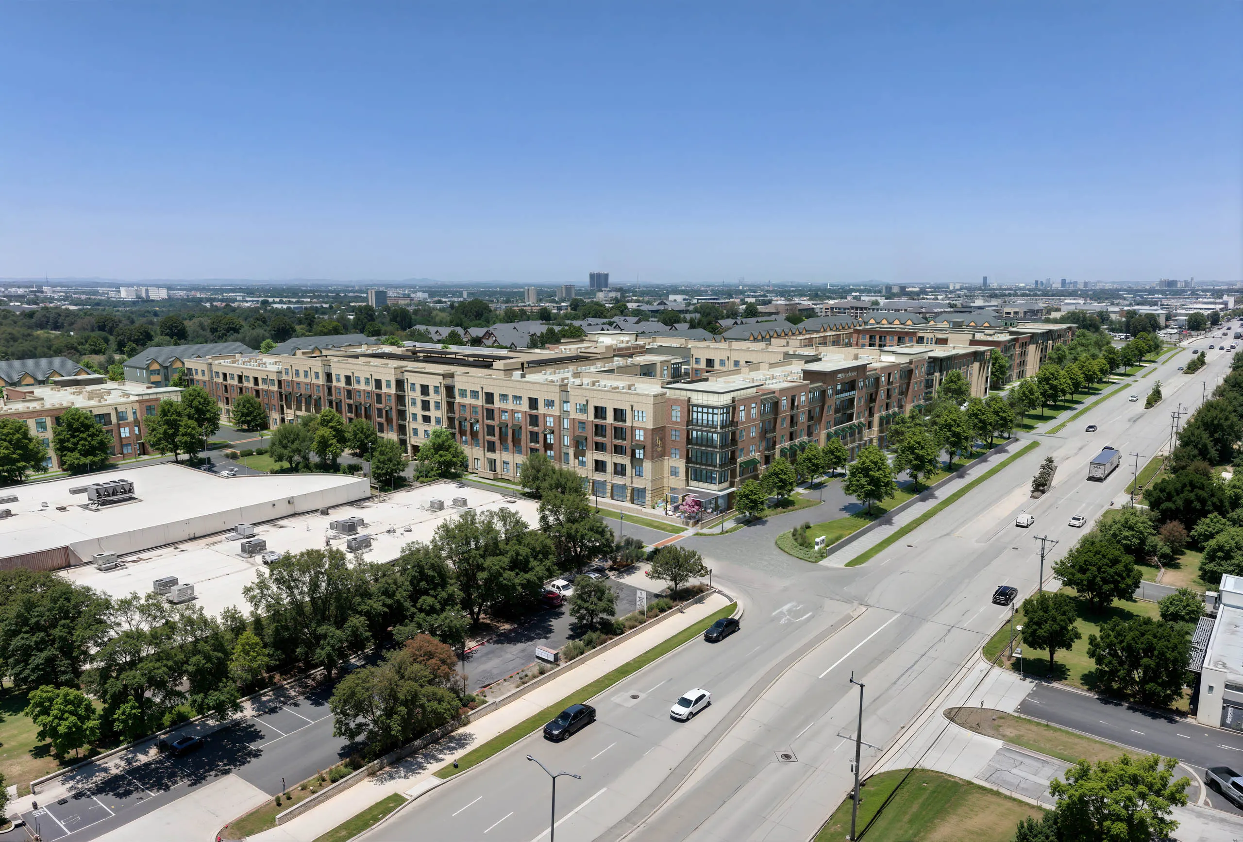 Aerial AMLI Treehouse view of the property with all buildings and several green trees in the medians with a busy street in front of the buildings
