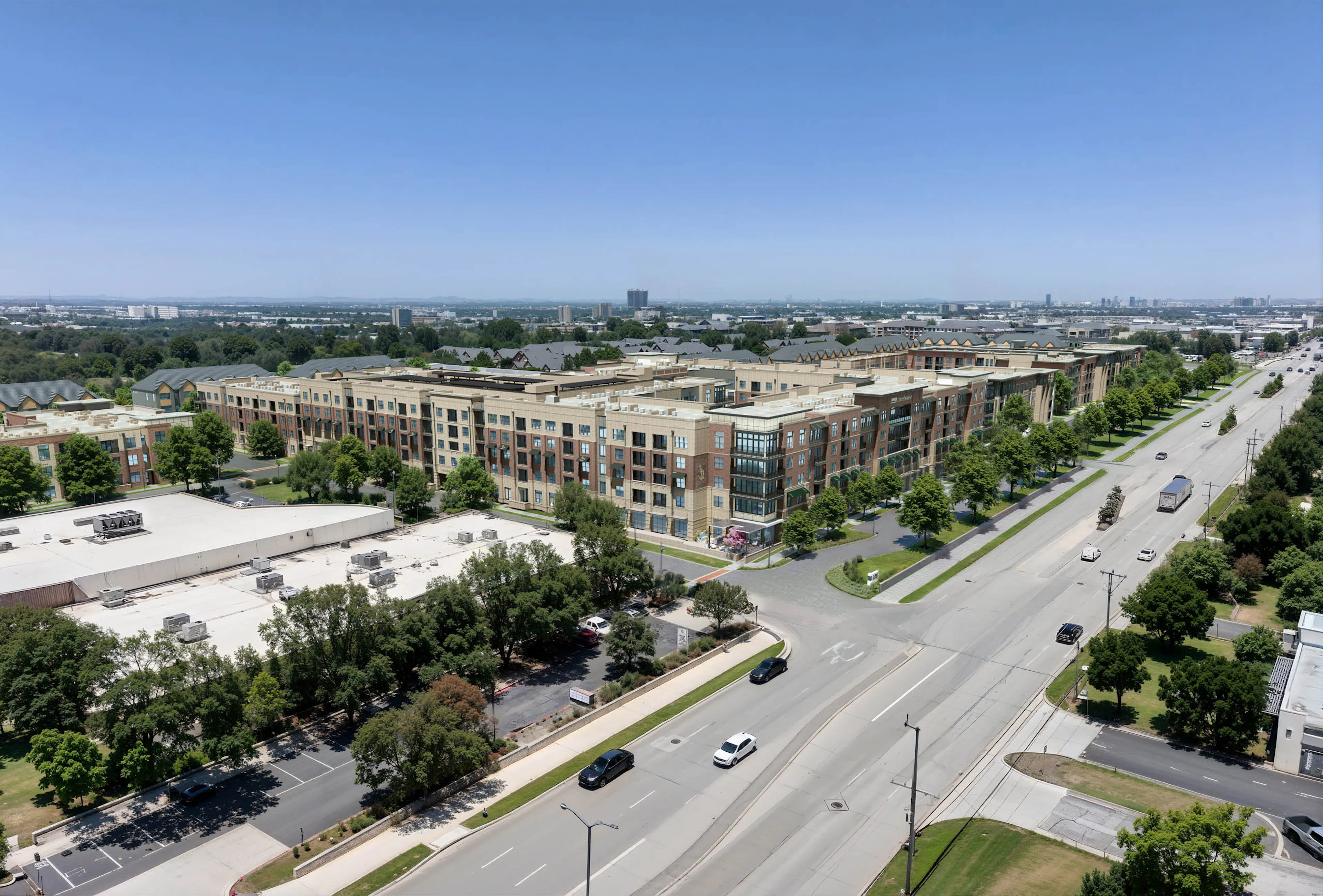 Aerial AMLI Treehouse view of the property with all buildings and several green trees in the medians with a busy street in front of the buildings