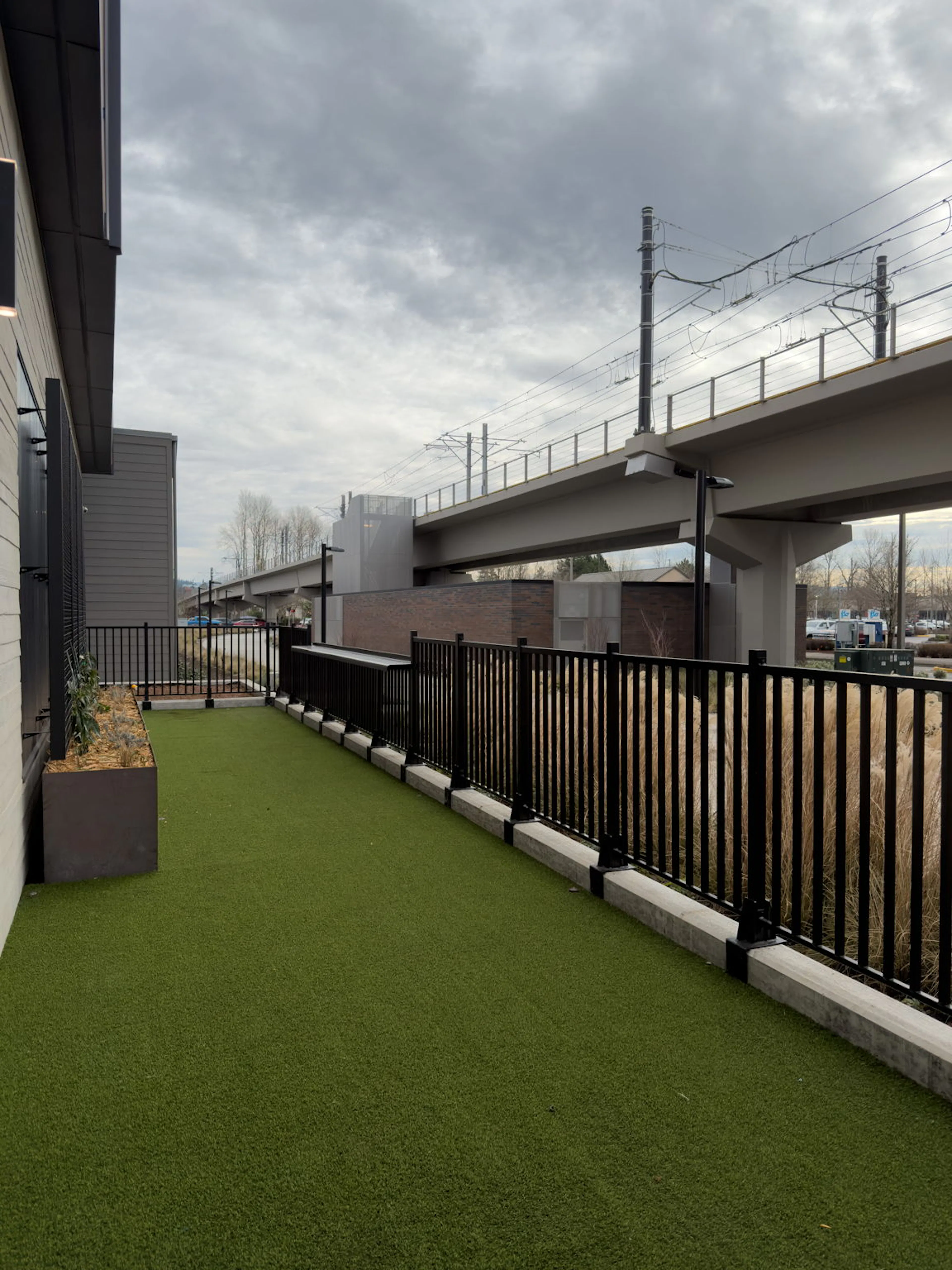A dog park at AMLI Redmond Way with the Light Rail in the background