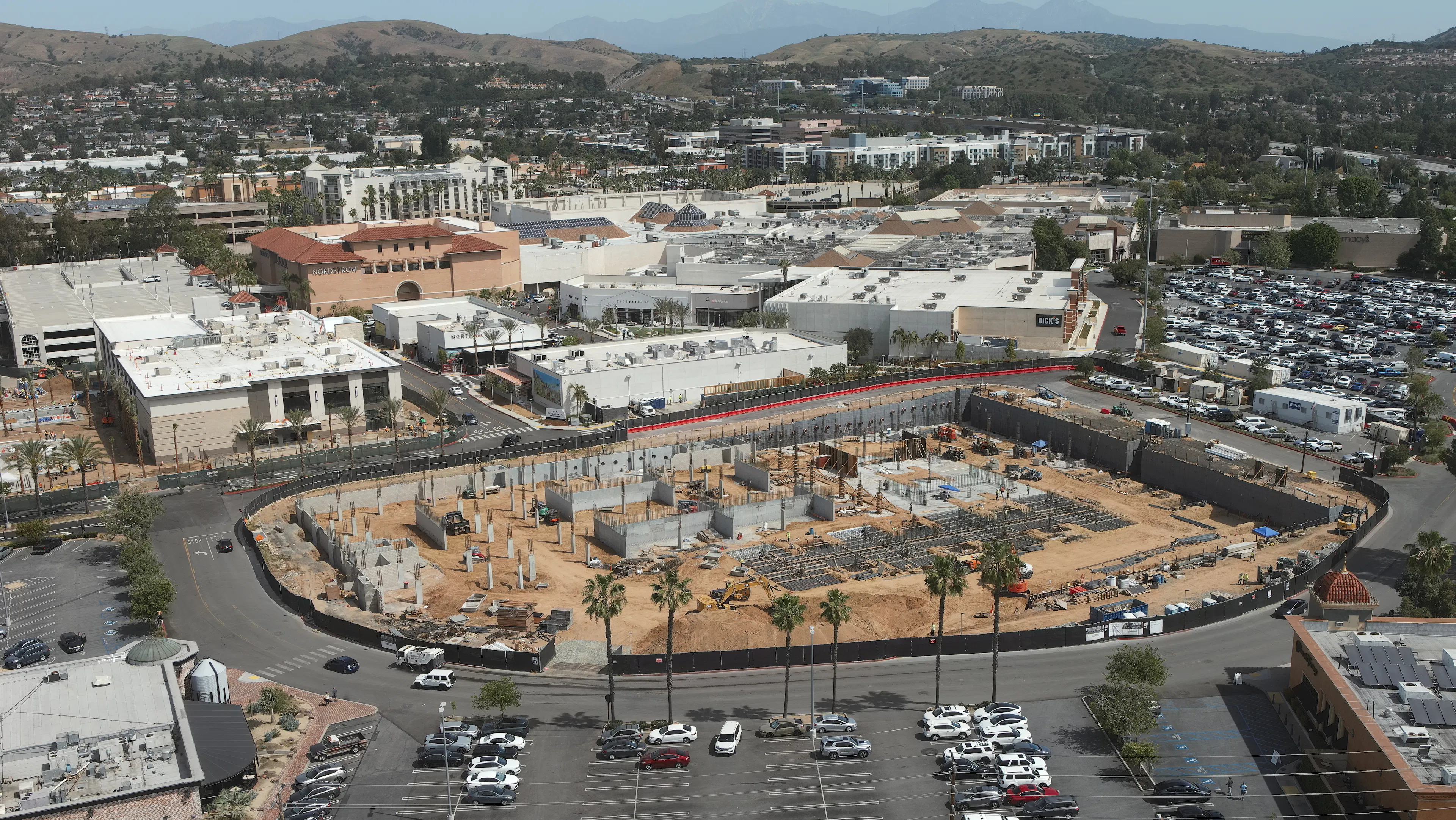 Aerial view of AMLI Brea construction site with garage columns poured