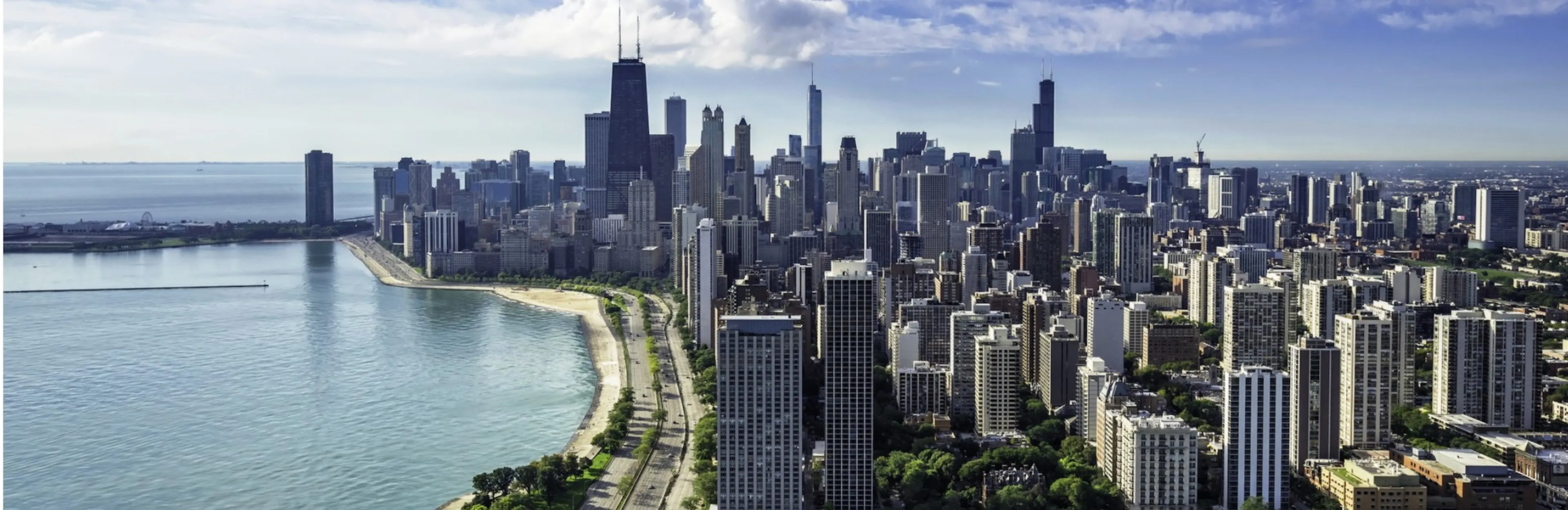 Panoramic daytime view of the Chicago skyline and high-rise buildings along Lake Michigan and Lake Shore Drive
