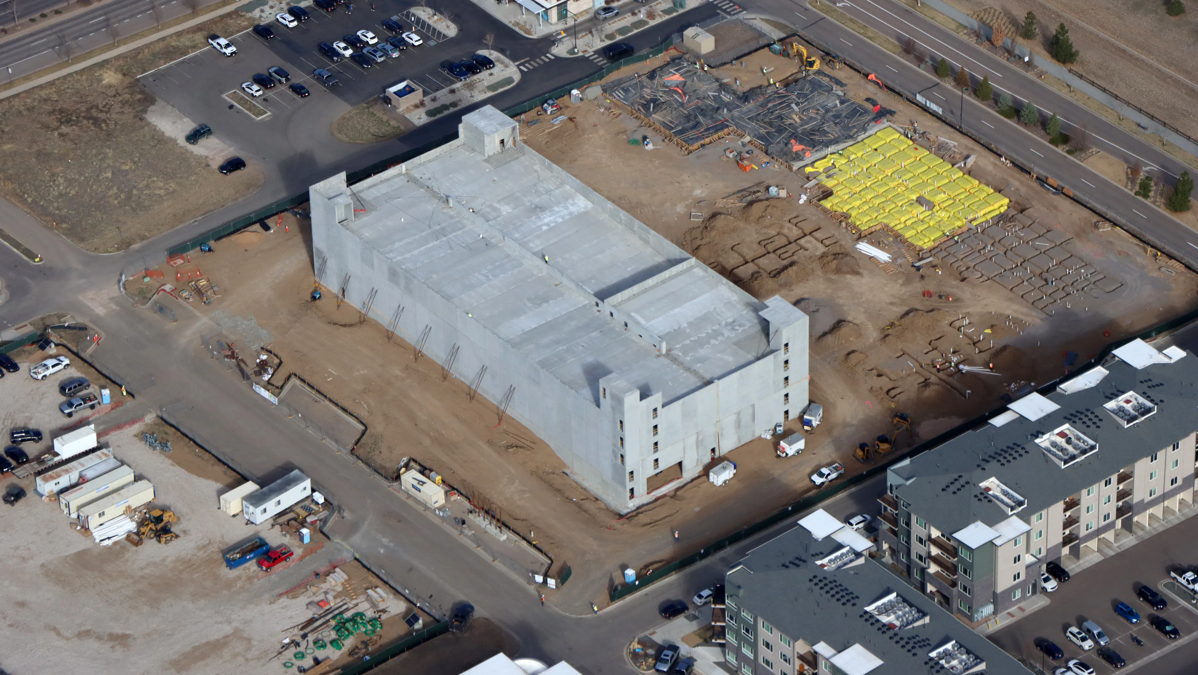 Aerial view of AMLI Village Park under construction with precast parking garage completed.