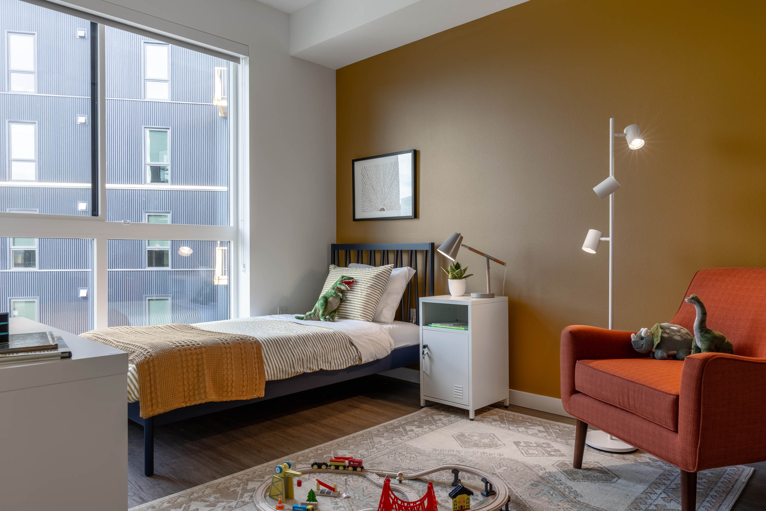 Child bedroom at AMLI Redmond Way apartments with large windows and children's toys/
