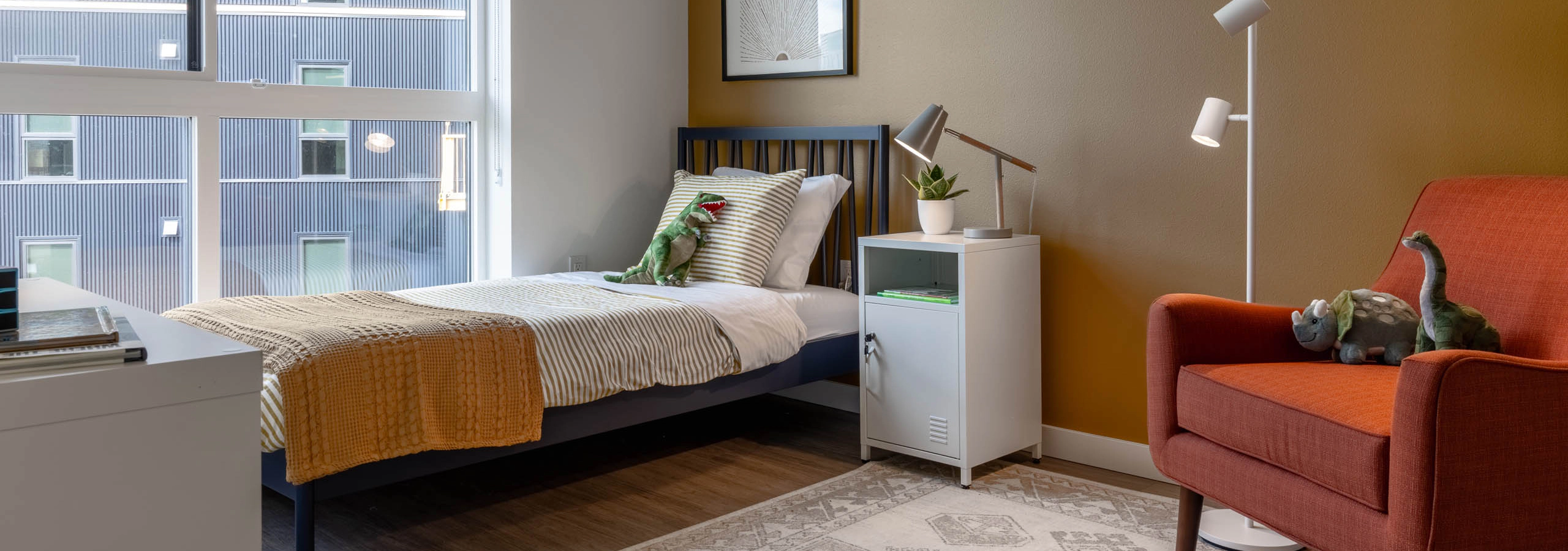 Child bedroom at AMLI Redmond Way apartments with large windows and children's toys/