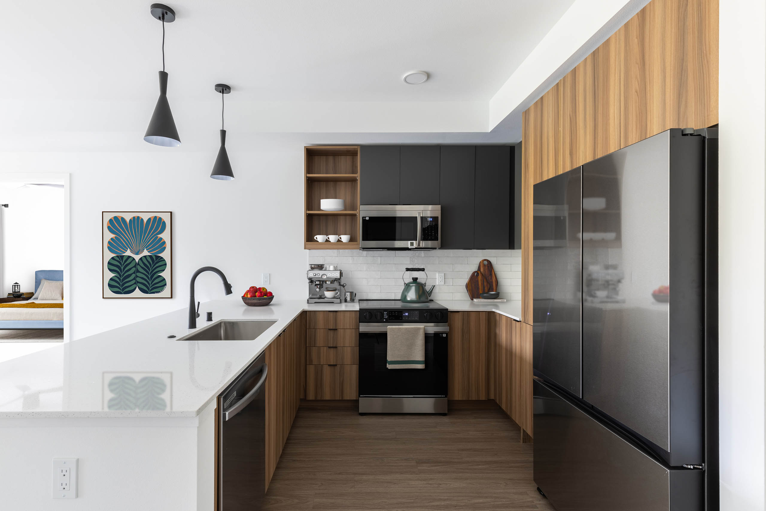 AMLI Redmond Way apartment interior with warm finish package and stainless steel appliances