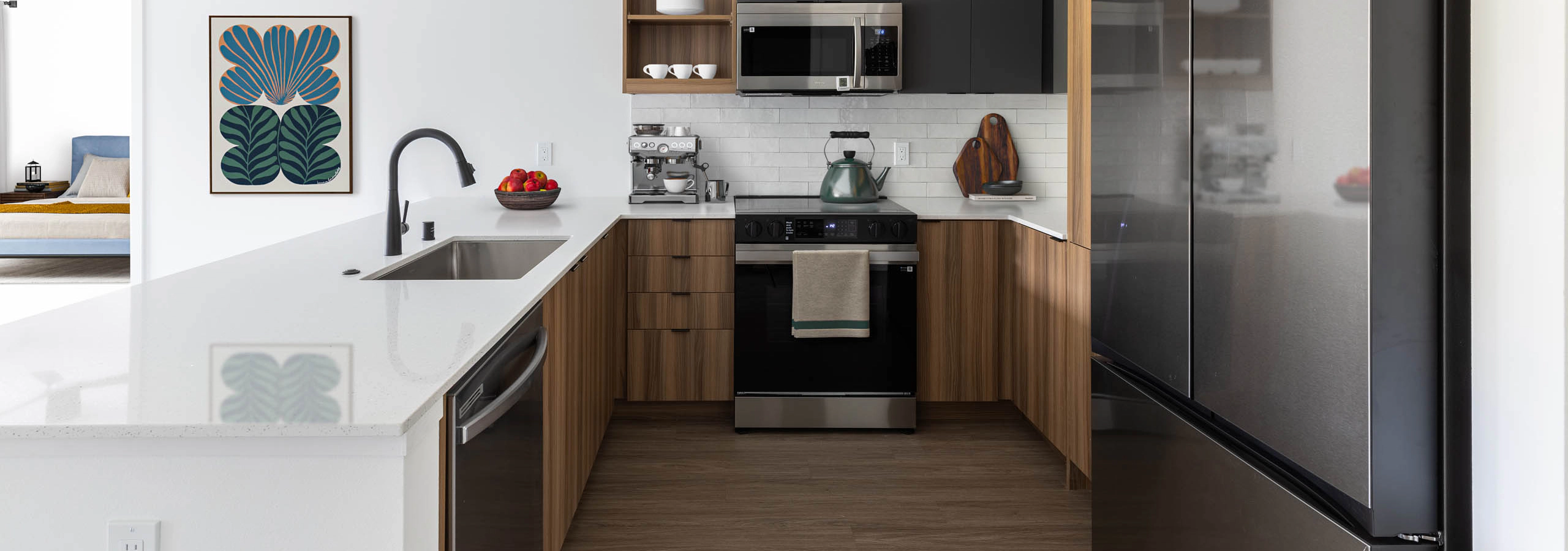 AMLI Redmond Way apartment interior with warm finish package and stainless steel appliances