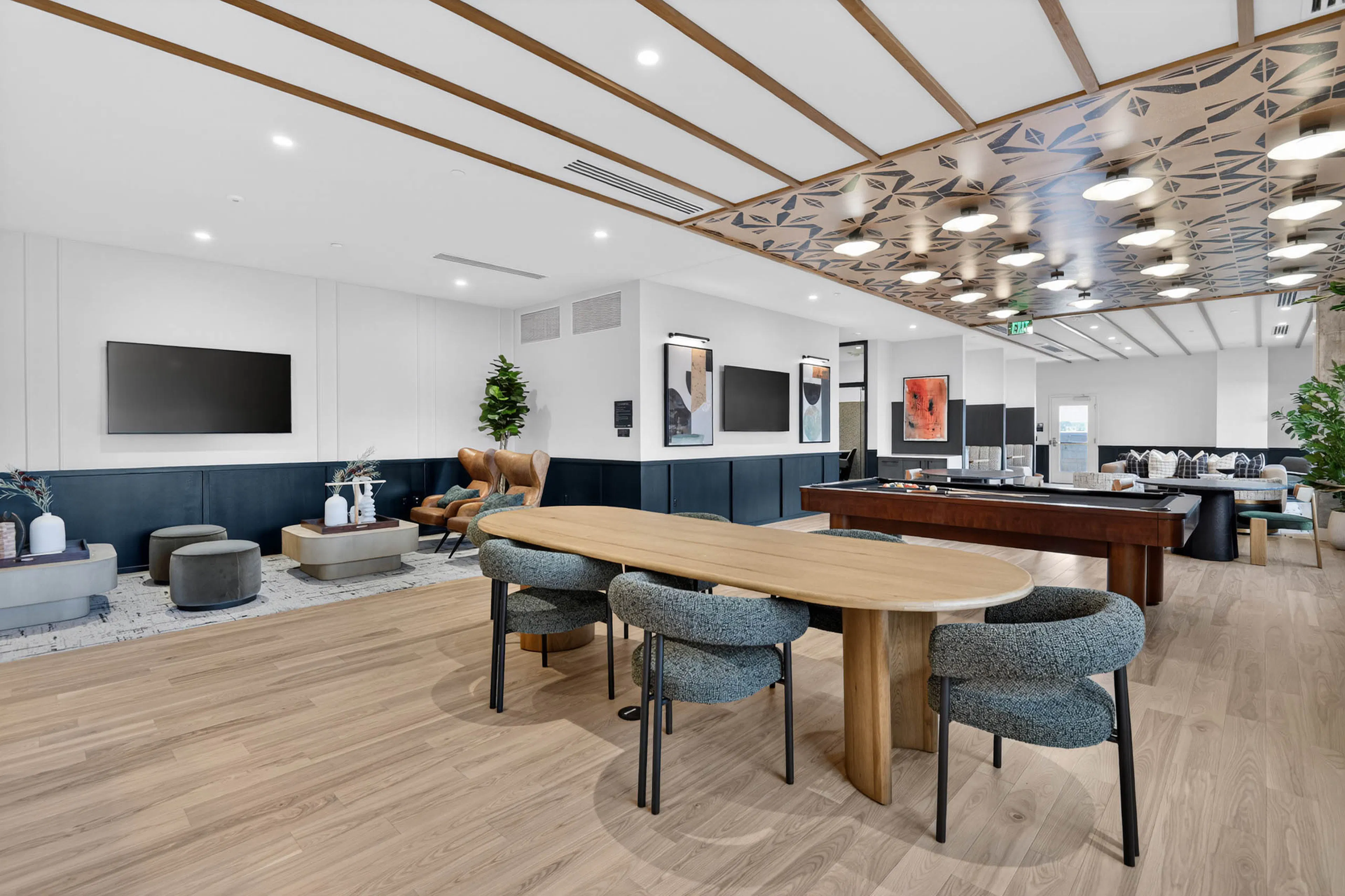 Community lounge at AMLI Golden Triangle apartments with built in booths sofa seating coffee tables and tall windows