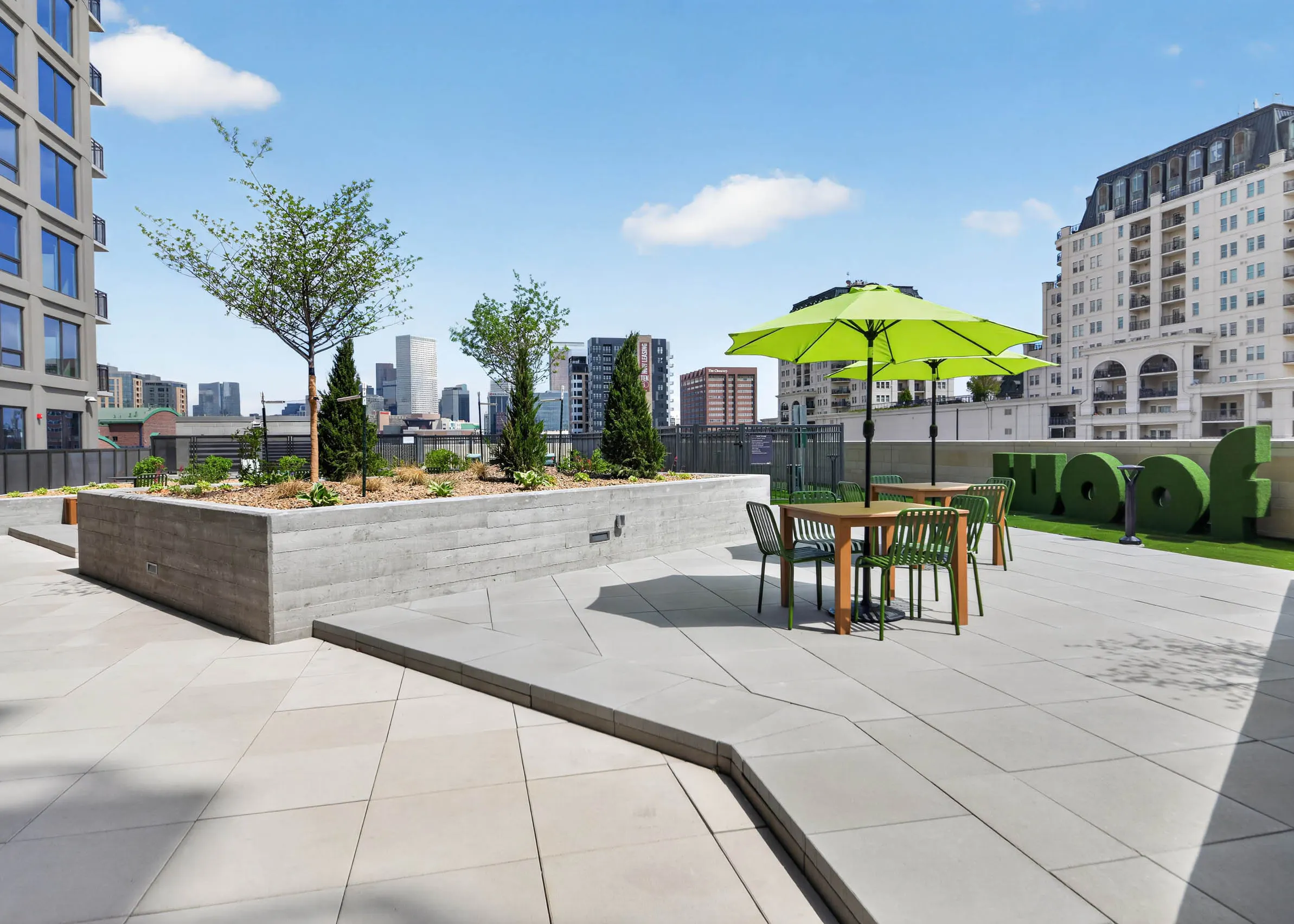 Outdoor fitness area at AMLI Golden Triangle apartments with turf surface punching bag training equipment and city views