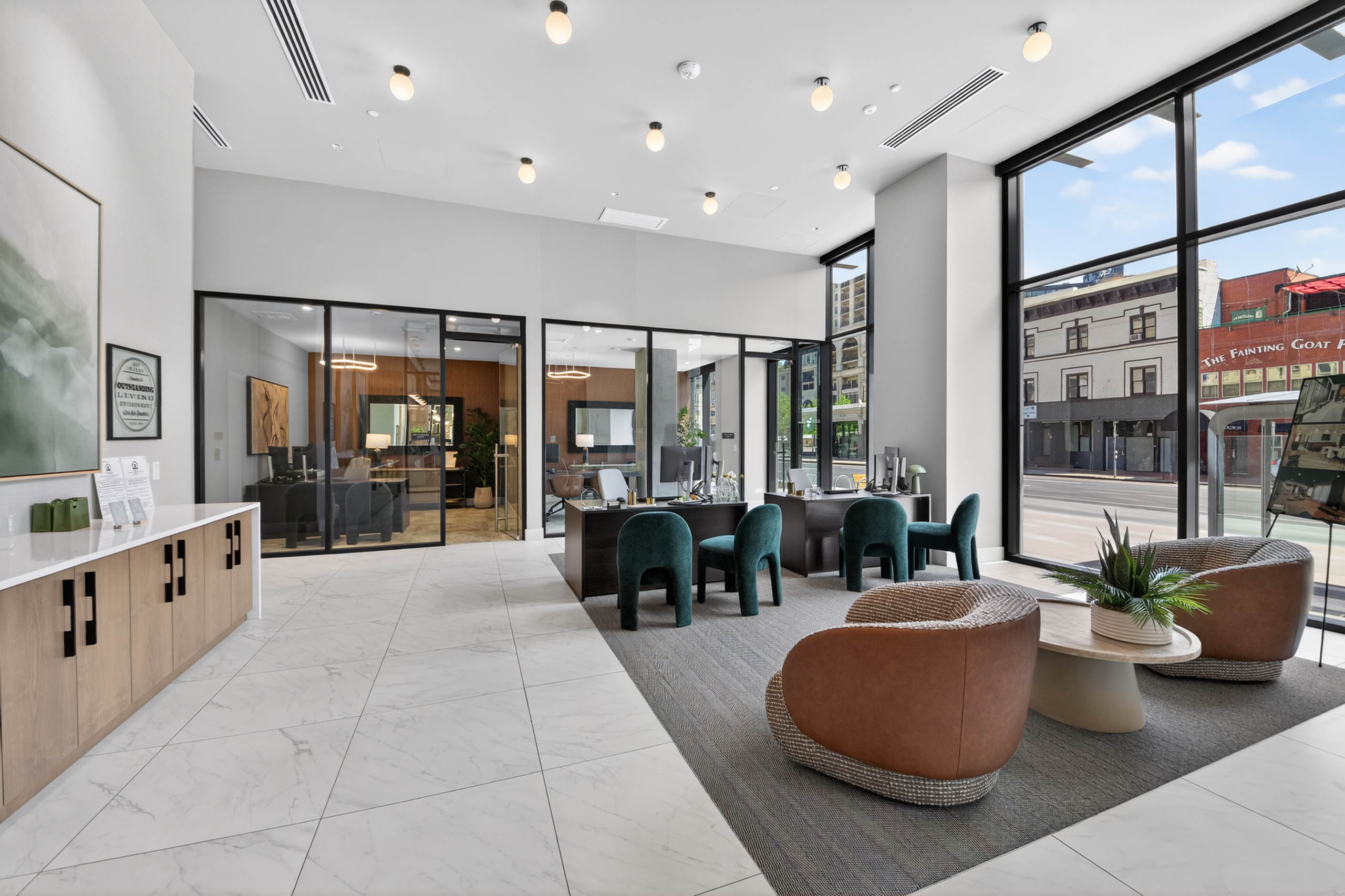 Leasing lobby at AMLI Golden Triangle apartments with seating areas front desk glass offices and street views