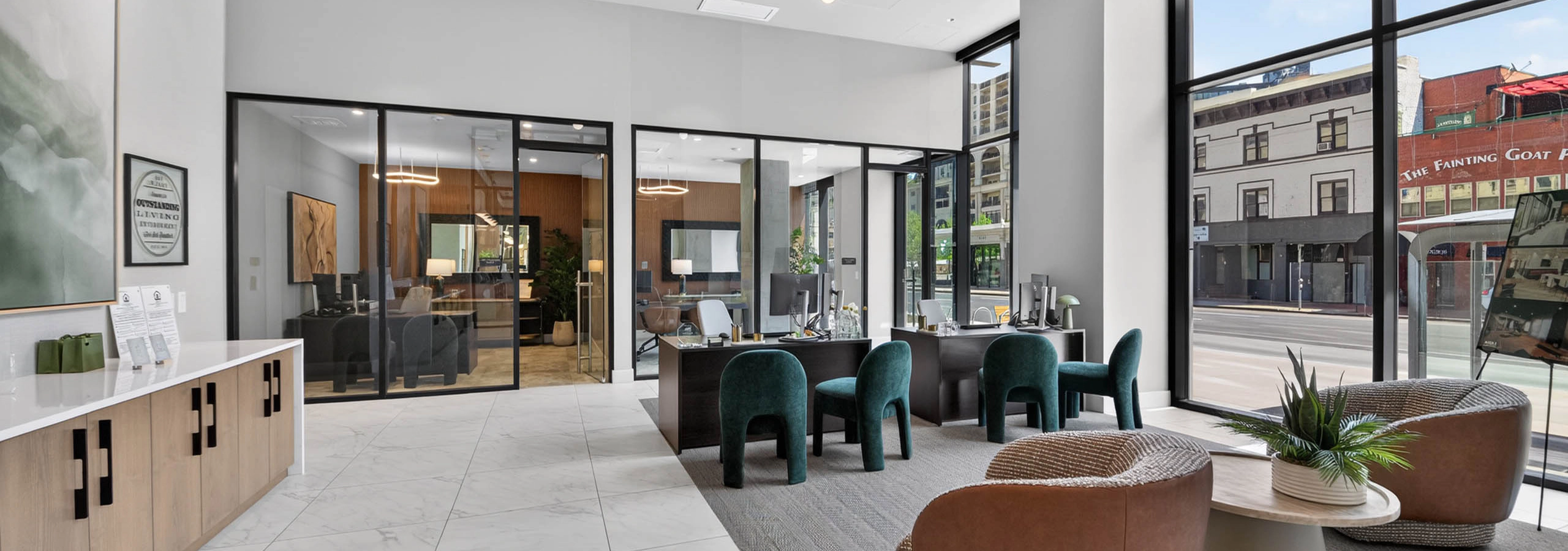 Leasing lobby at AMLI Golden Triangle apartments with seating areas front desk glass offices and street views