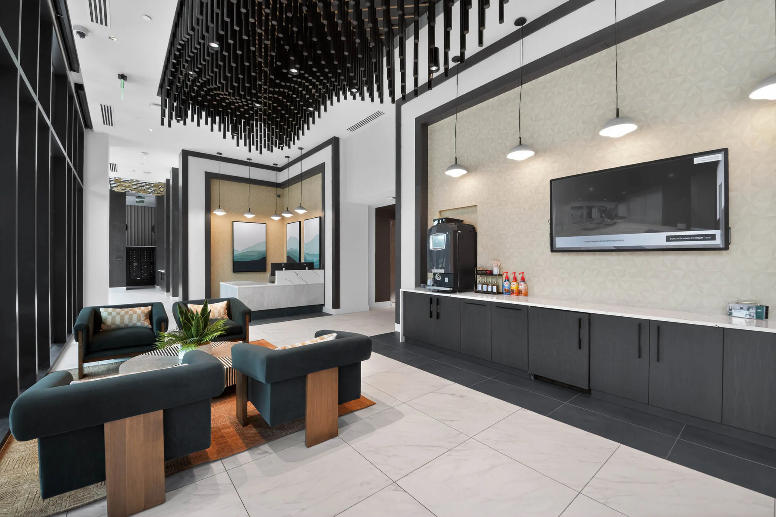 Lobby at AMLI Golden Triangle apartments with lounge seating coffee station modern lighting and concierge desk area