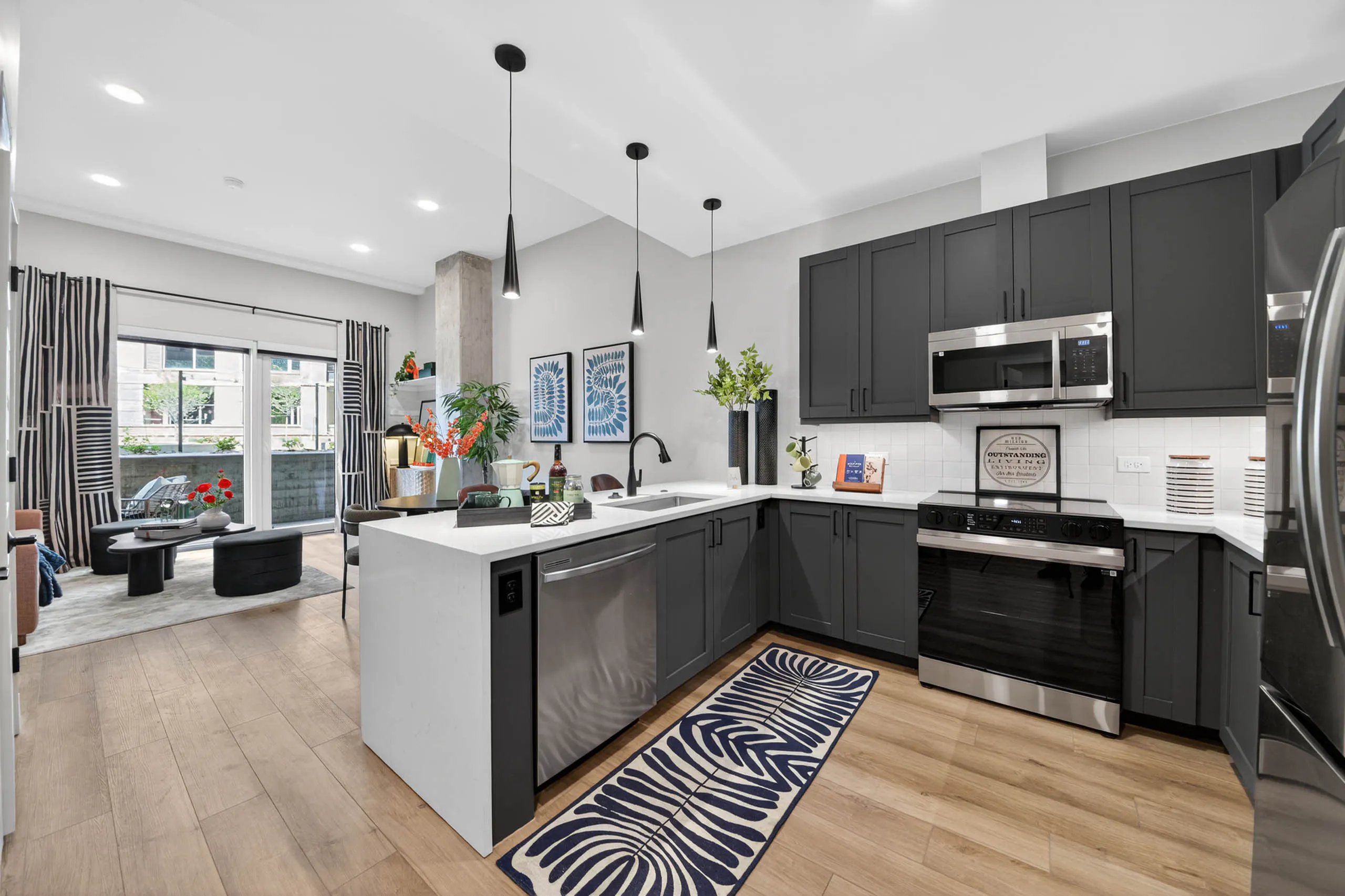 AMLI Golden Triangle apartment kitchen with stainless appliances - Denver, CO