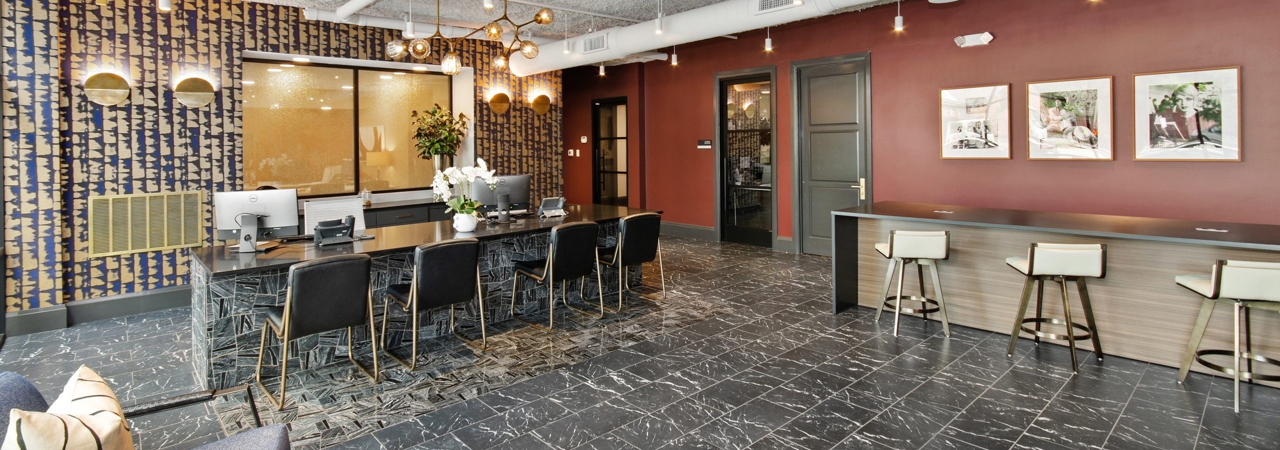 AMLI Quadrangle apartments leasing office with ample varied seating and two computer stations on a black and gray desk