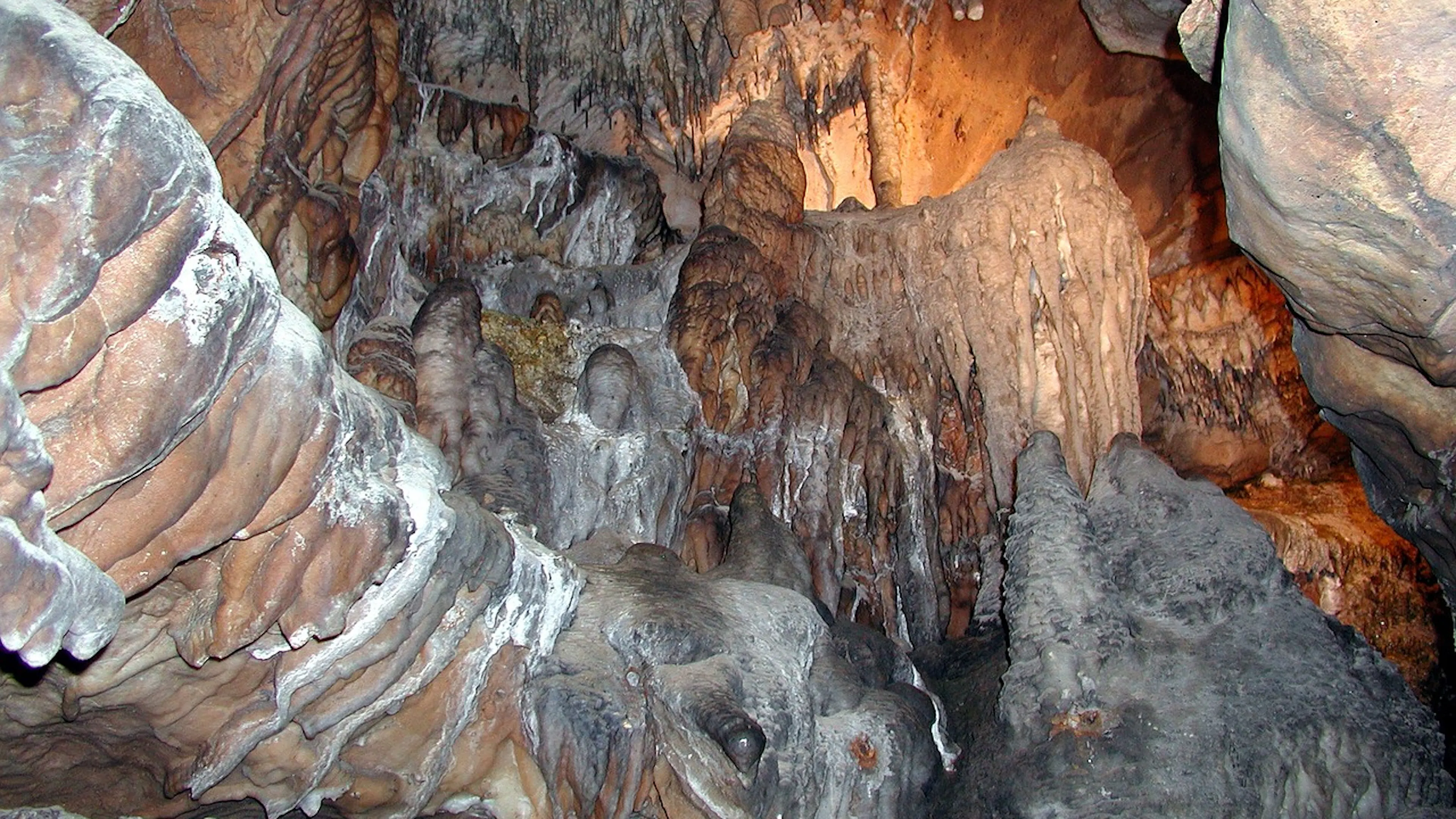 The interior of a limestone cave looking up toward the ceiling