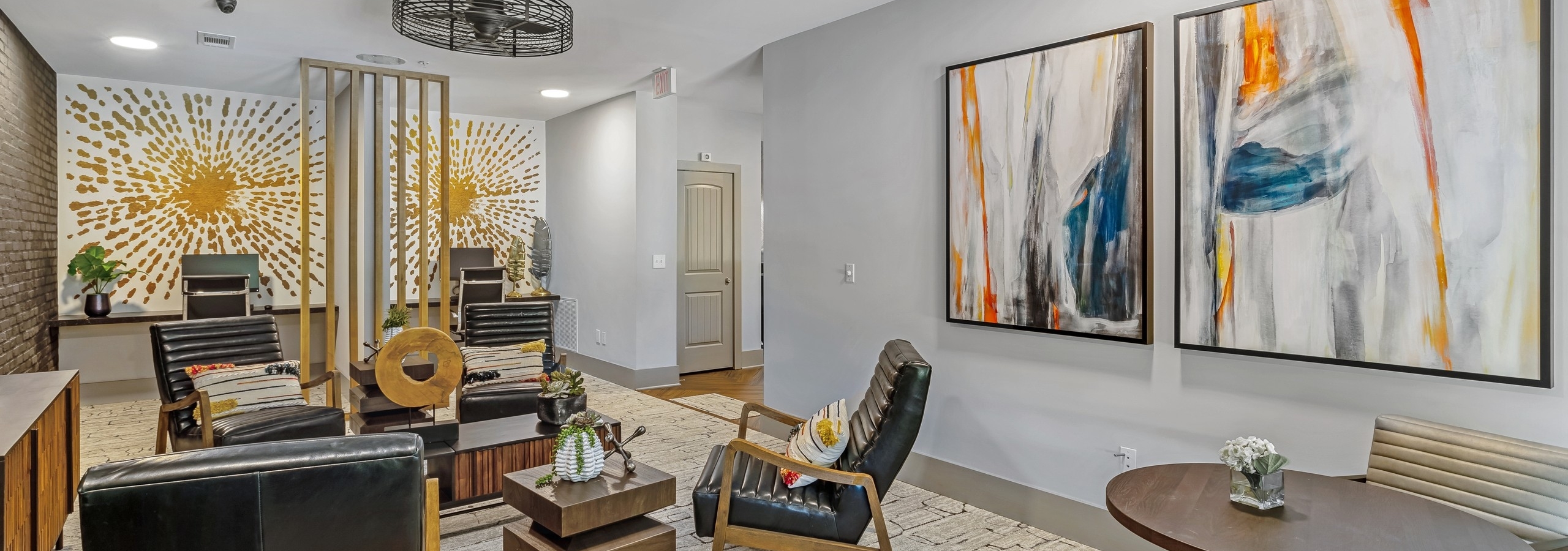 Interior view of the resident lounge at AMLI North Point with armchair seating and modern tables and abstract artwork