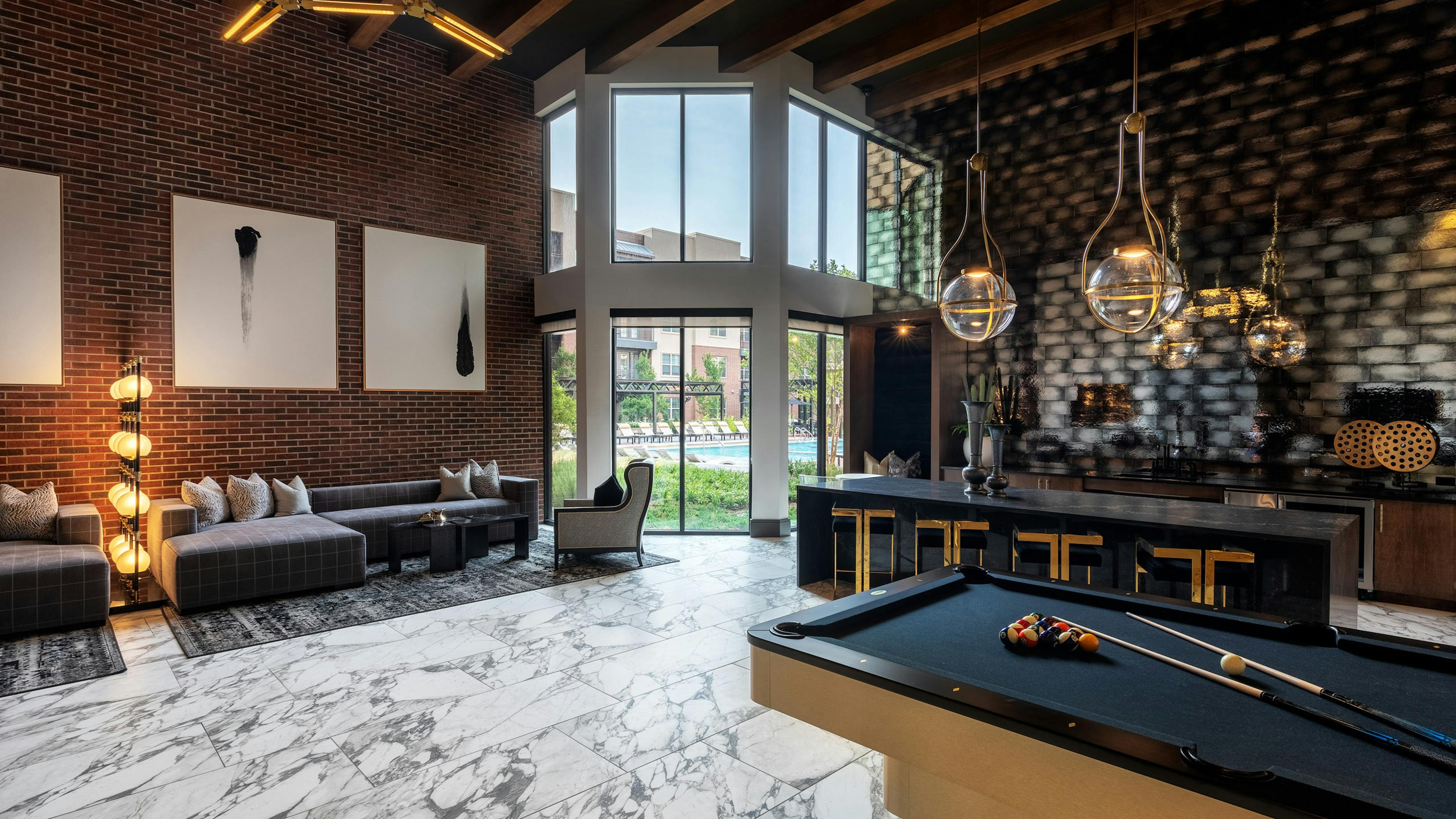 AMLI Grapevine apartment building clubroom with gray tile flooring and catering kitchen and lounge seating and pool table