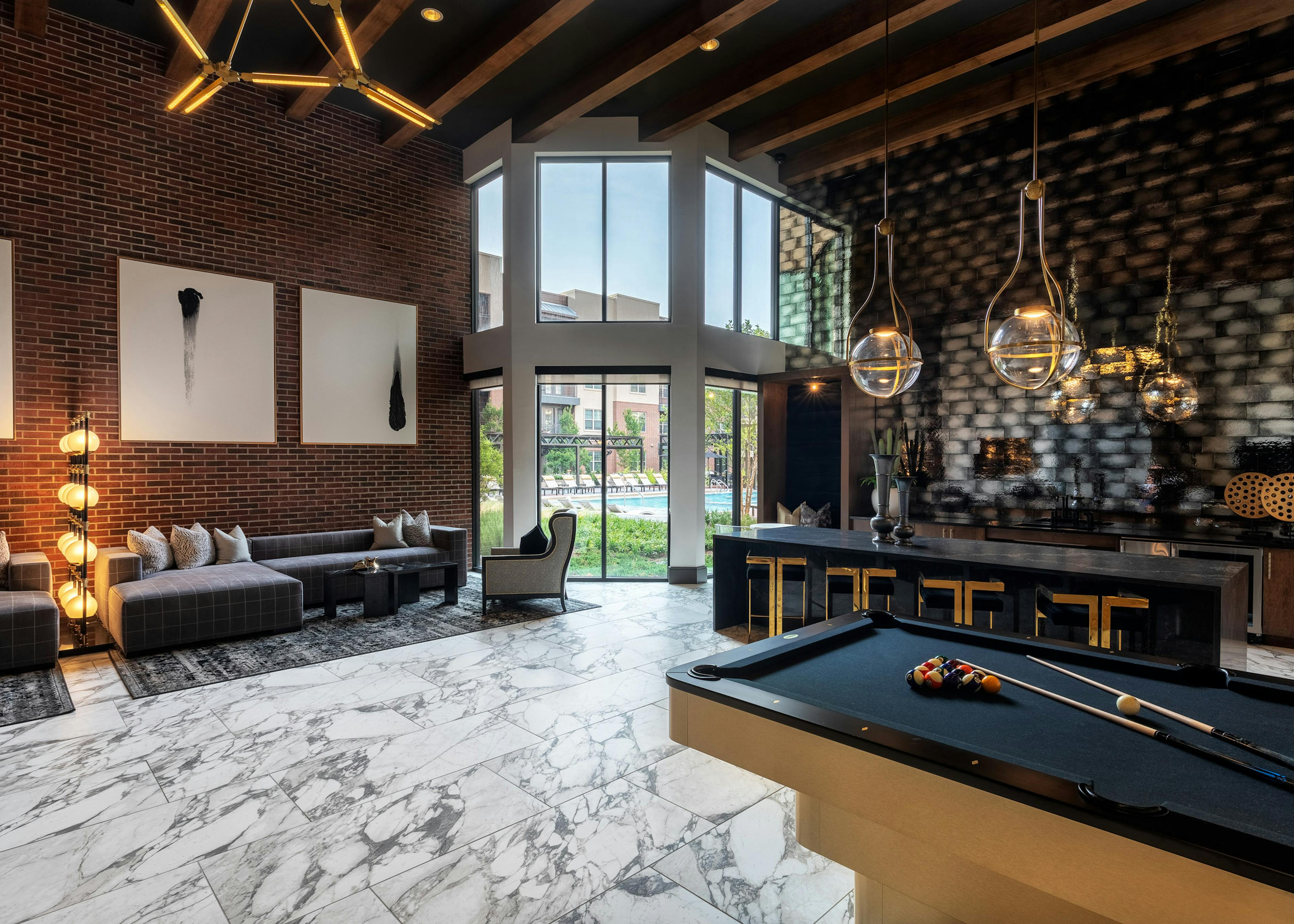 AMLI Grapevine apartment building clubroom with gray tile flooring and catering kitchen and lounge seating and pool table