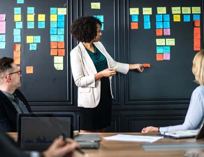 Woman giving presentation to team