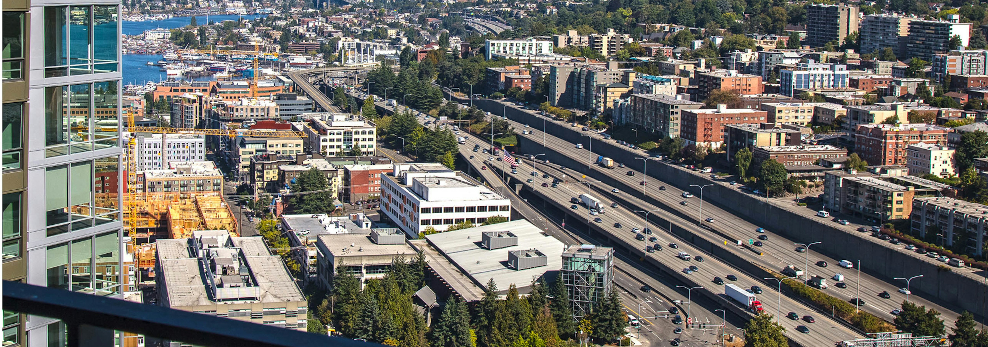 Sunny Seattle with the exterior view from AMLI Arc of highway I-5 facing north Capitol Hill and slight view of Lake Union