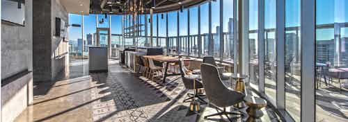 Interior club-room of AMLI Arc with demonstration kitchen beer tap and seating