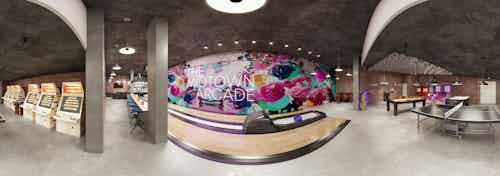 Panoramic rendering of the Arcade bowling alley and game room with bar and games and tables at AMLI Midtown Miami apartments