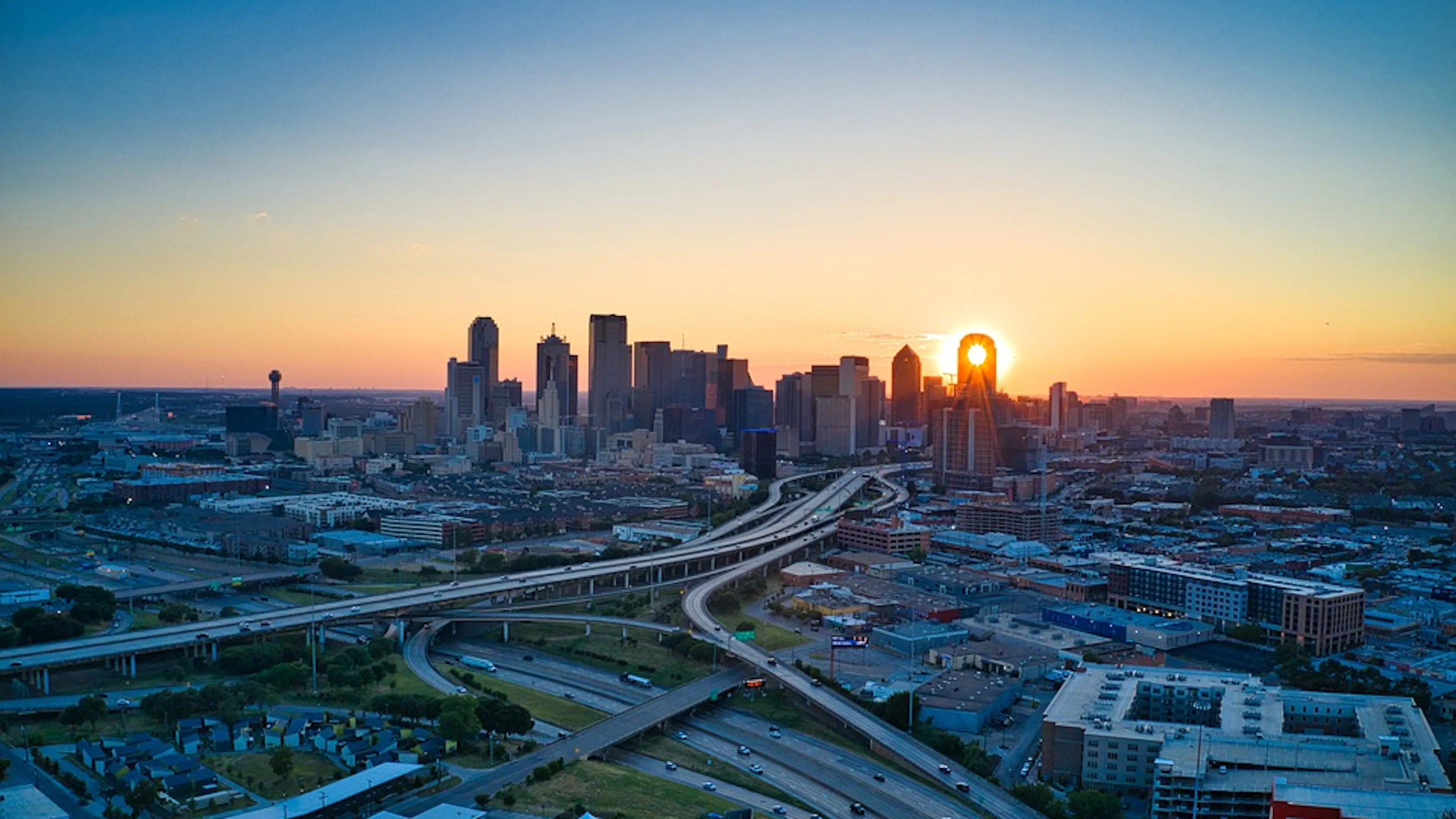 Dallas skyline with a blue and orange sunset in the background 