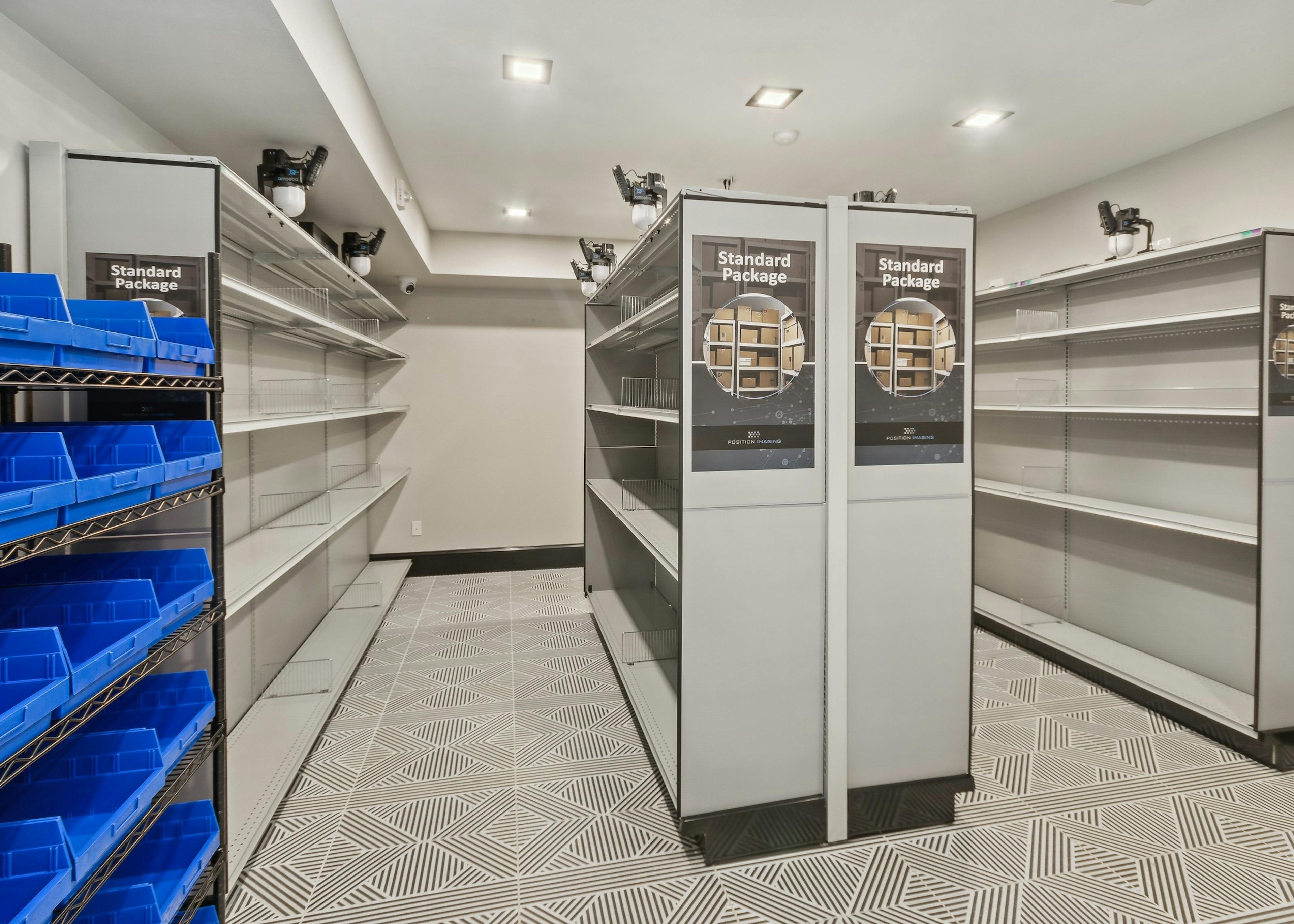 Resident package room at AMLI Campion Trail apartments with gray racking for standard packages and blue bins for flat packages