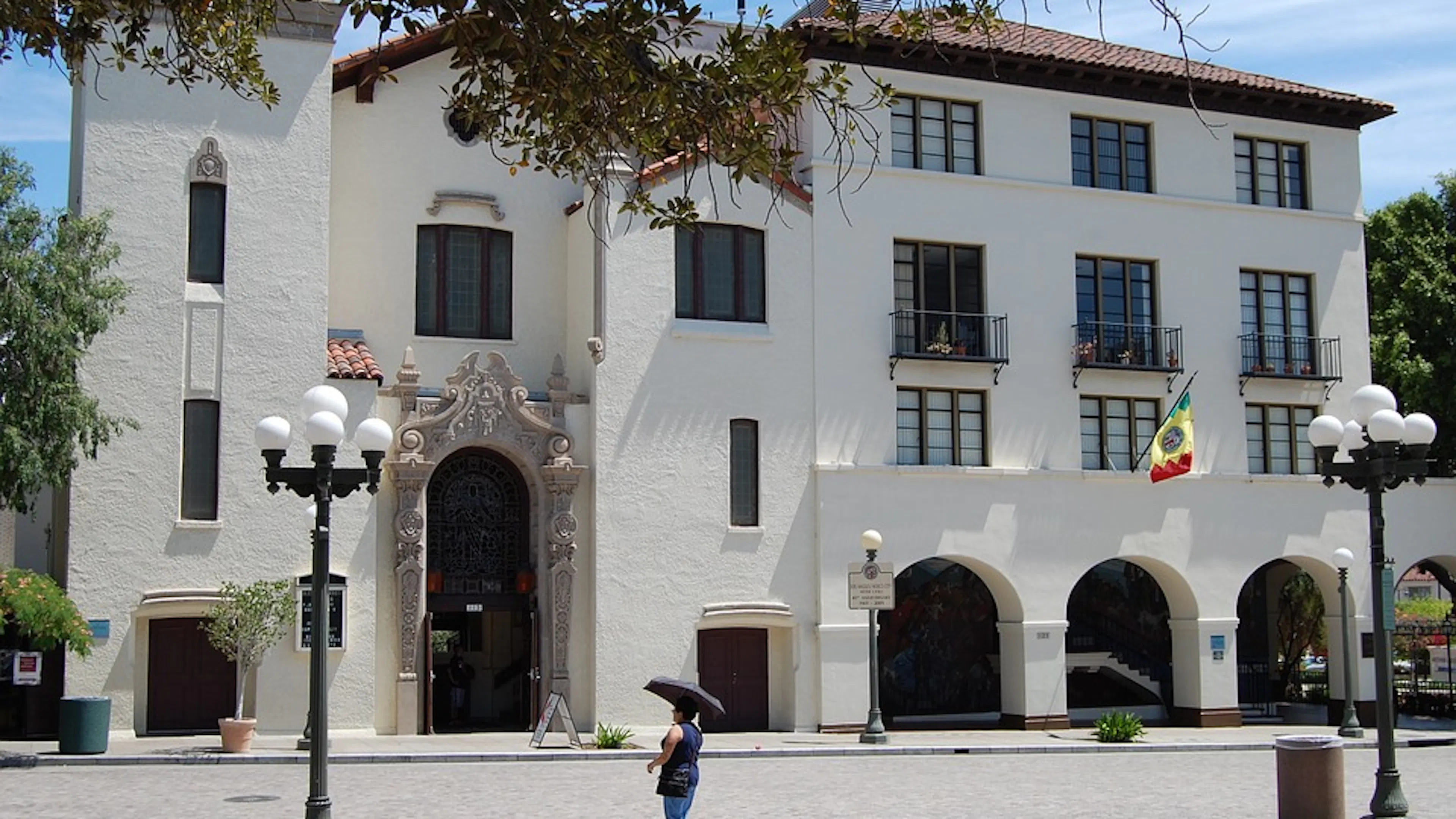 Façade of a late 18th century Californian building with tall arches and long windows