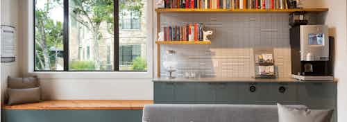 AMLI Covered Bridge java bar with light tile backsplash, Starbucks coffee, TAZO tea, and water dispenser