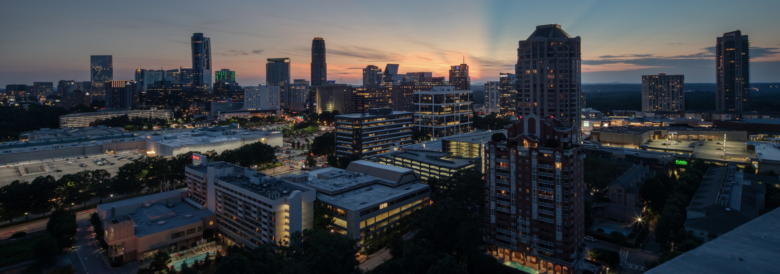 Exterior view of a gorgeous cityscape of tall buildings with varying heights after the sun has set in Atlanta at dusk