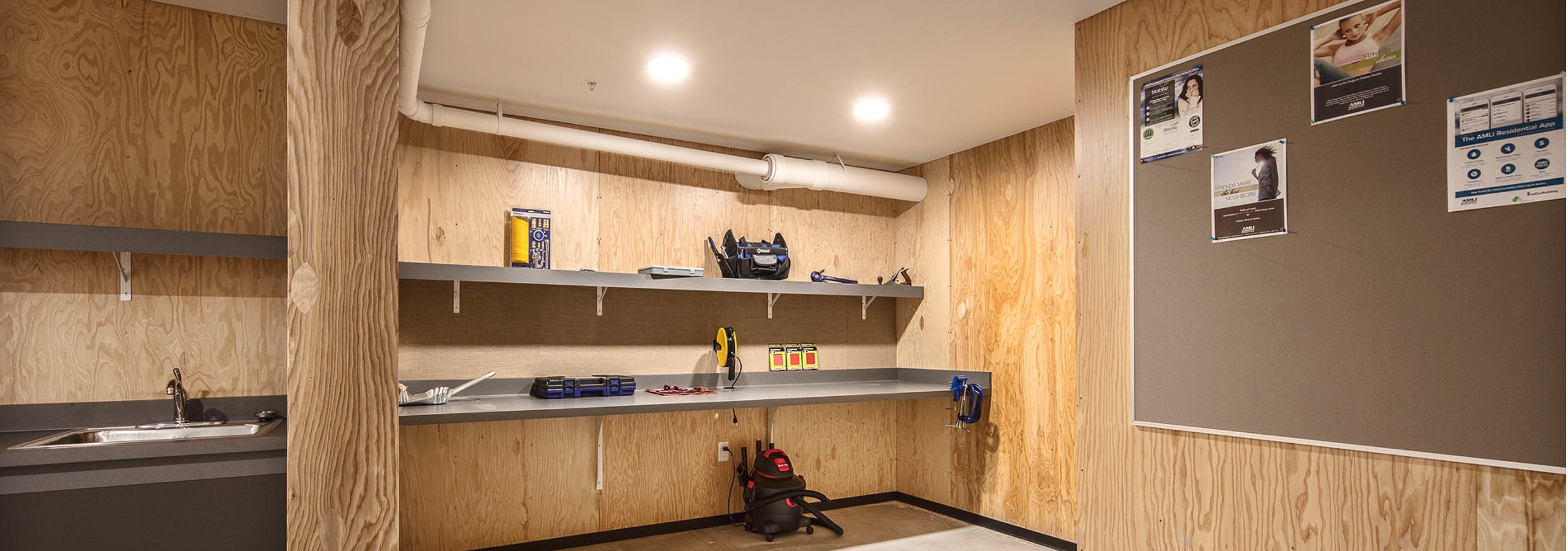 Interior of the DIY work room at AMLI Wallingford with ample work space tools bulletin board and a place to be creative