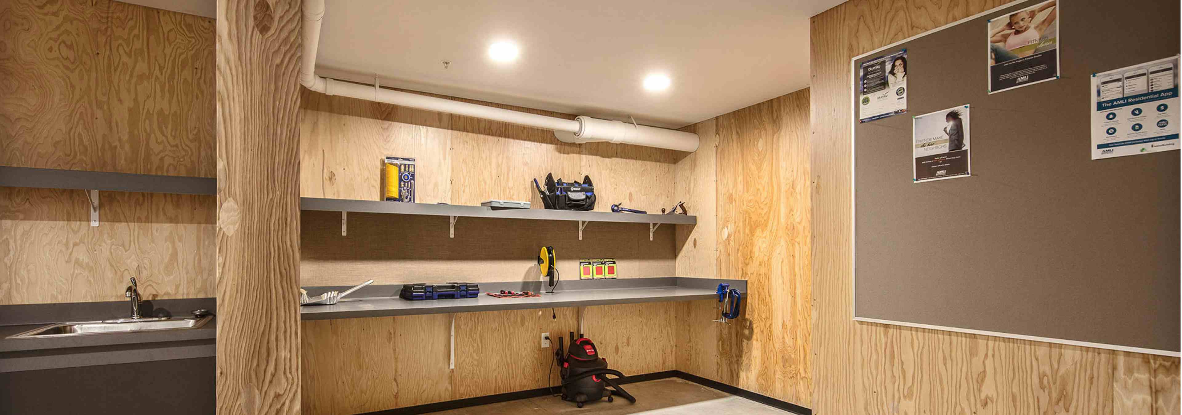 Interior of the DIY work room at AMLI Wallingford with ample work space tools bulletin board and a place to be creative 